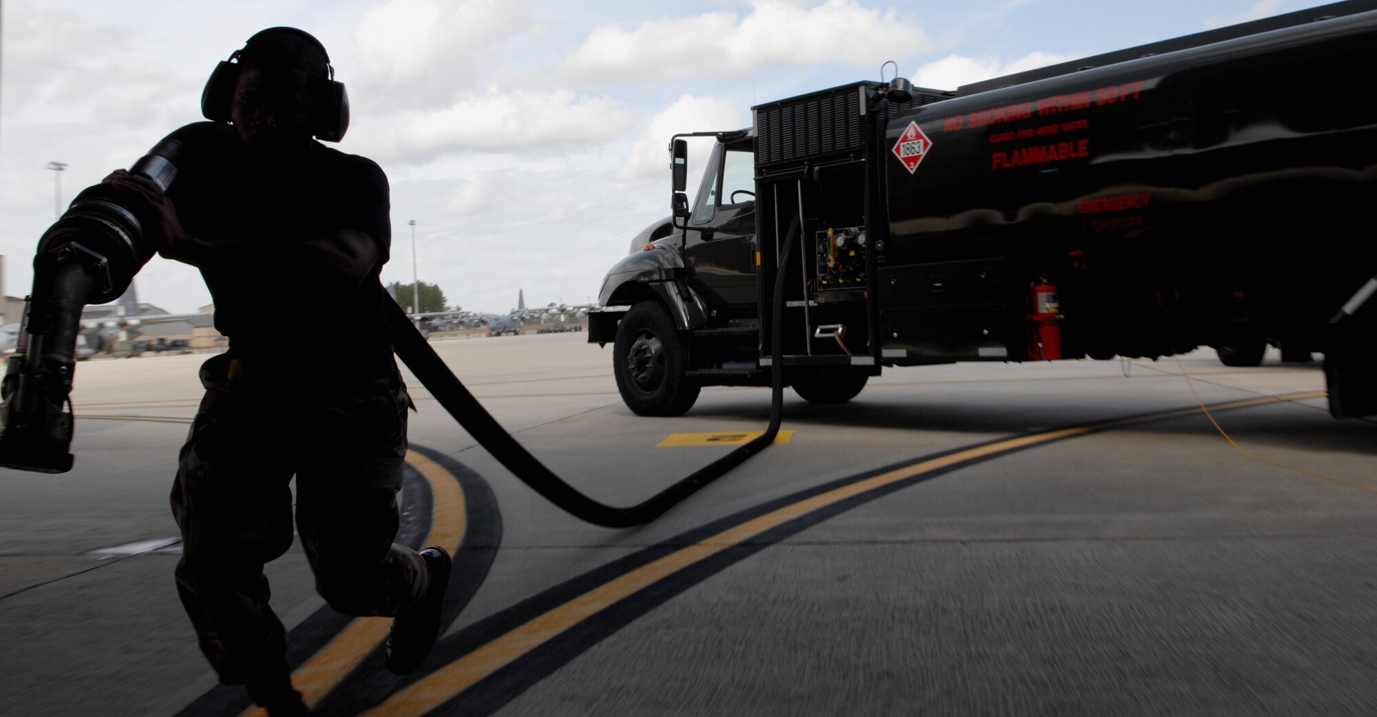 MOODY AIR FORCE BASE, Ga. – Staff Sgt. Ruben Watson, 23rd Logistics Readiness Squadron fuel distribution operator, pulls a single point connector hose from a fuel truck here Feb 6.  One fuel truck can carry up to six thousand gallons of aviation fuel. (U.S. Air Force photo by Senior Airman Angelita Lawrence)