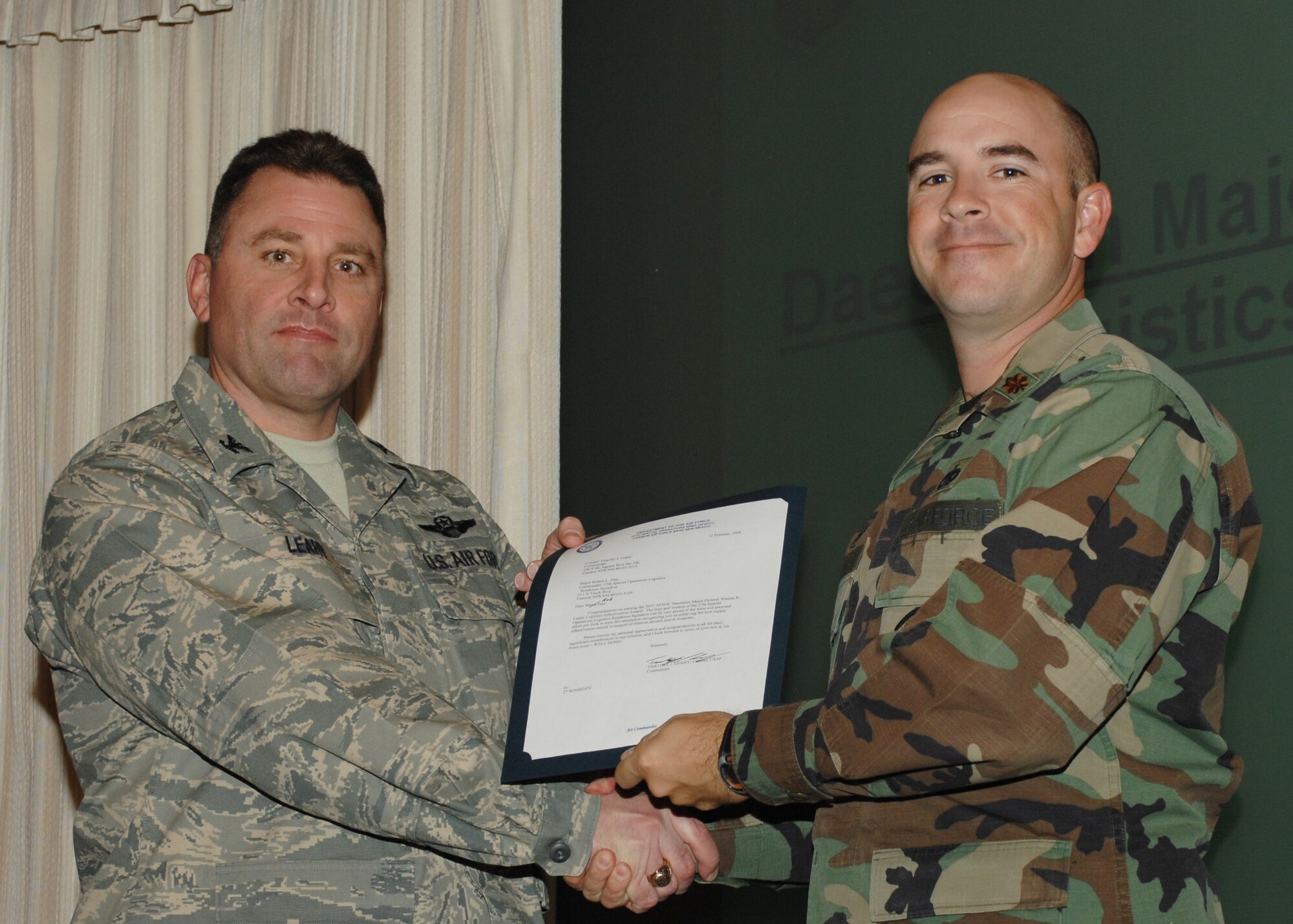 CANNON AIR FORCE BASE, N.M. -- Col. Timothy Leahy, 27th Special Operations Wing commander,  presents Maj. Warren Carter with the 2008 Logistics Effectiveness award Feb. 12.  Maj. Carter is assigned to the 27th Special Operations Logistic Readiness Squadron.  (U.S. Air Force photo by Airman 1st Class James R. Bell)