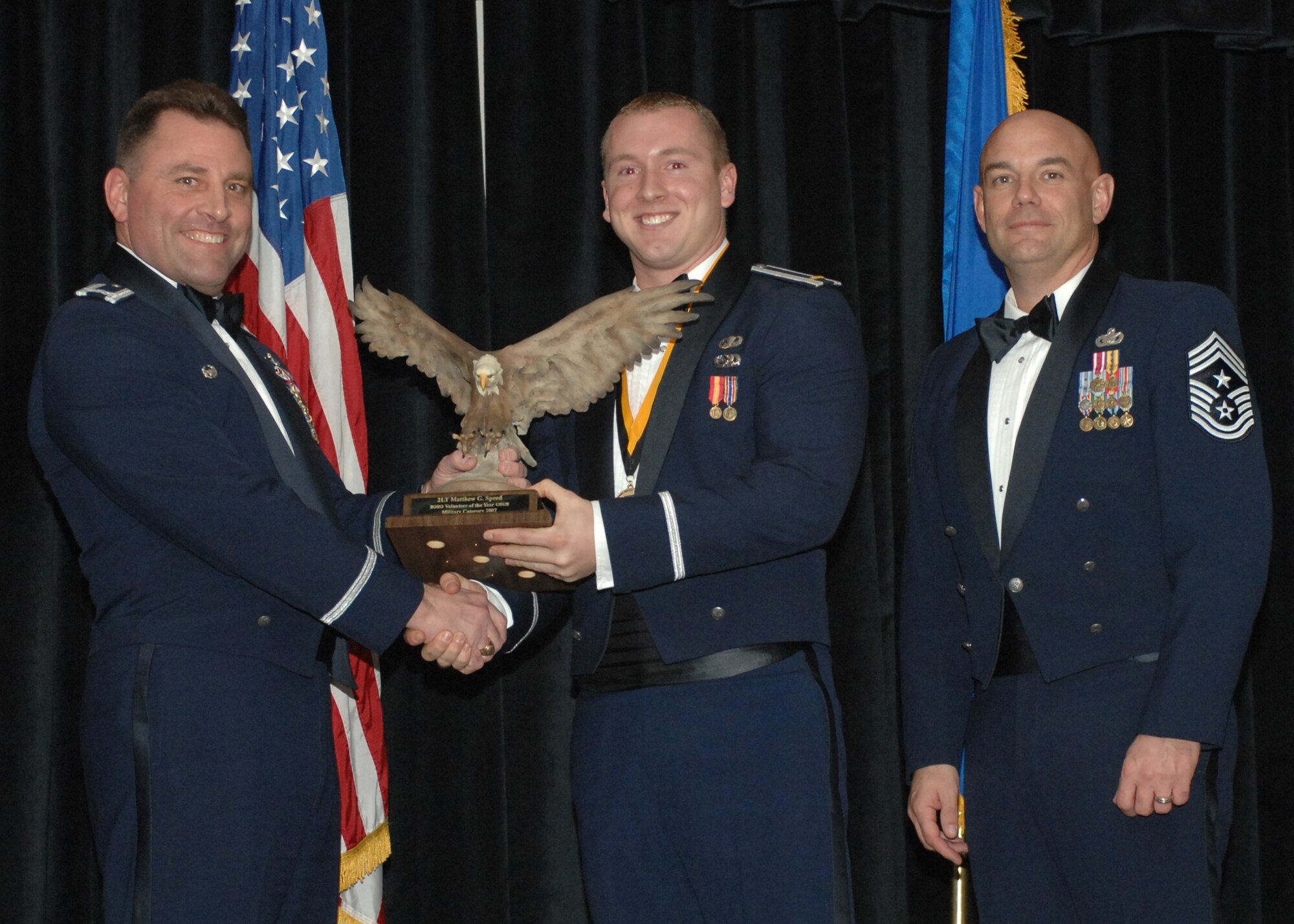 CANNON AIR FORCE BASE, N,M. -- Col. Timothy Leahy (left), 27th Special Operations Wing commander  and Chief Master Sergeant Daniel Fischer, wing command chief, present 2nd Lt. Matthew Speed with the Military Volunteer of the Year award on Feb. 9 during the wing annual awards dinner at The Landing. Lt Speed is assigned to the 712th Special Operations Maintenance Squadron.  (U.S. Air Force photo/Airman 1st Class James Bell)