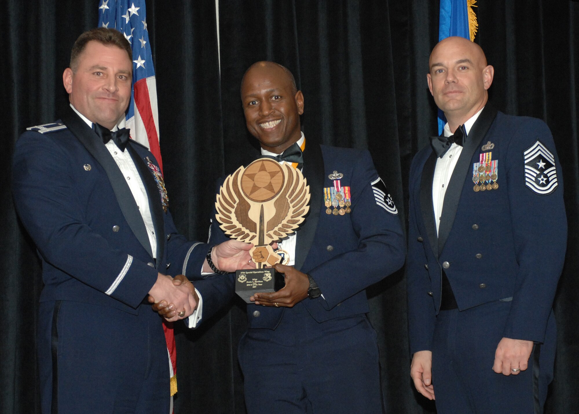 Cannon Air Force Base- Colonol Timmothy Leahy(left) and Chief Master Sergeant Daniel Fischer(right) presents Master Sergeant Drake L. Davidson with Senior Noncomissioned Officer of the Year February 9, 2008.  MSgt Davidson is from the 27th Special Operations Mission Support Group.  (U.S. Air Force photo by A1C James R. Bell)
