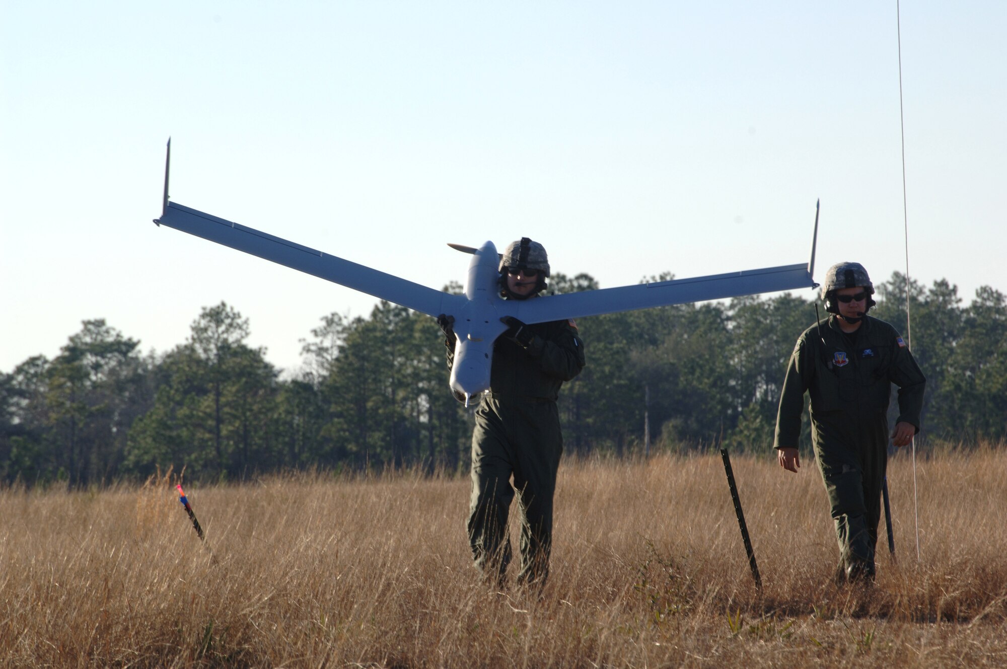 Team members from the 820th Security Forces Group at Moody Air Force Base, Ga., carry the Scan Eagle unmanned aircraft system after a demonstration to highlight its capabilities here Feb. 7. Air Force Special Operations Command is the lead command for SUAS and have been working with the team to prepare and certify them to employ the system in the near future. (U.S. Air Force Photo/Senior Airman Emily Moore)