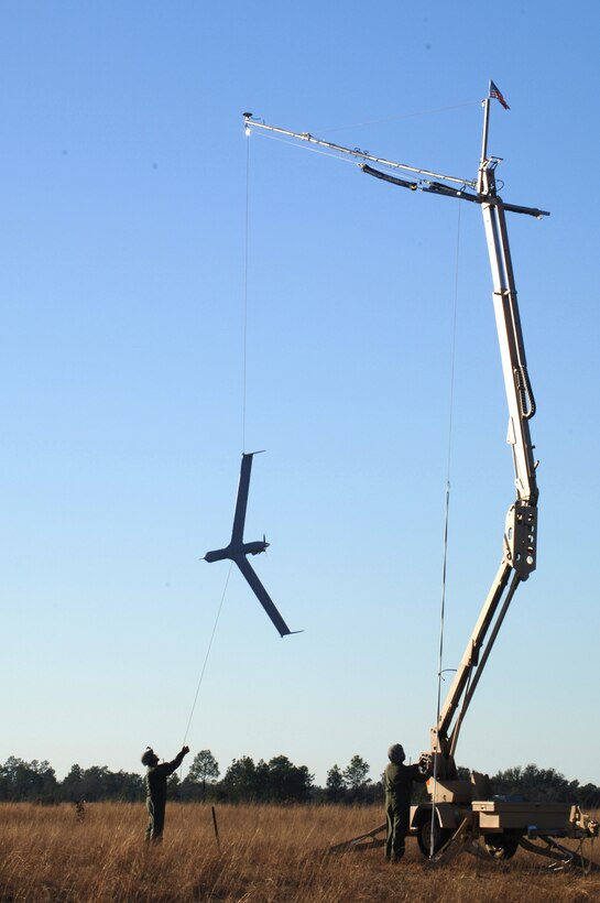 Team members from the 820th Security Forces Group at Moody Air Force Base, Ga., carefully lower the Scan Eagle unmanned aircraft system after it was recovered by the Skyhook system during a demonstration to highlight its capabilities here Feb. 7. Air Force Special Operations Command is the lead command for SUAS and have been working with the team to prepare and certify them to employ the system in the near future. (U.S. Air Force Photo/ Senior Airman Emily Moore)