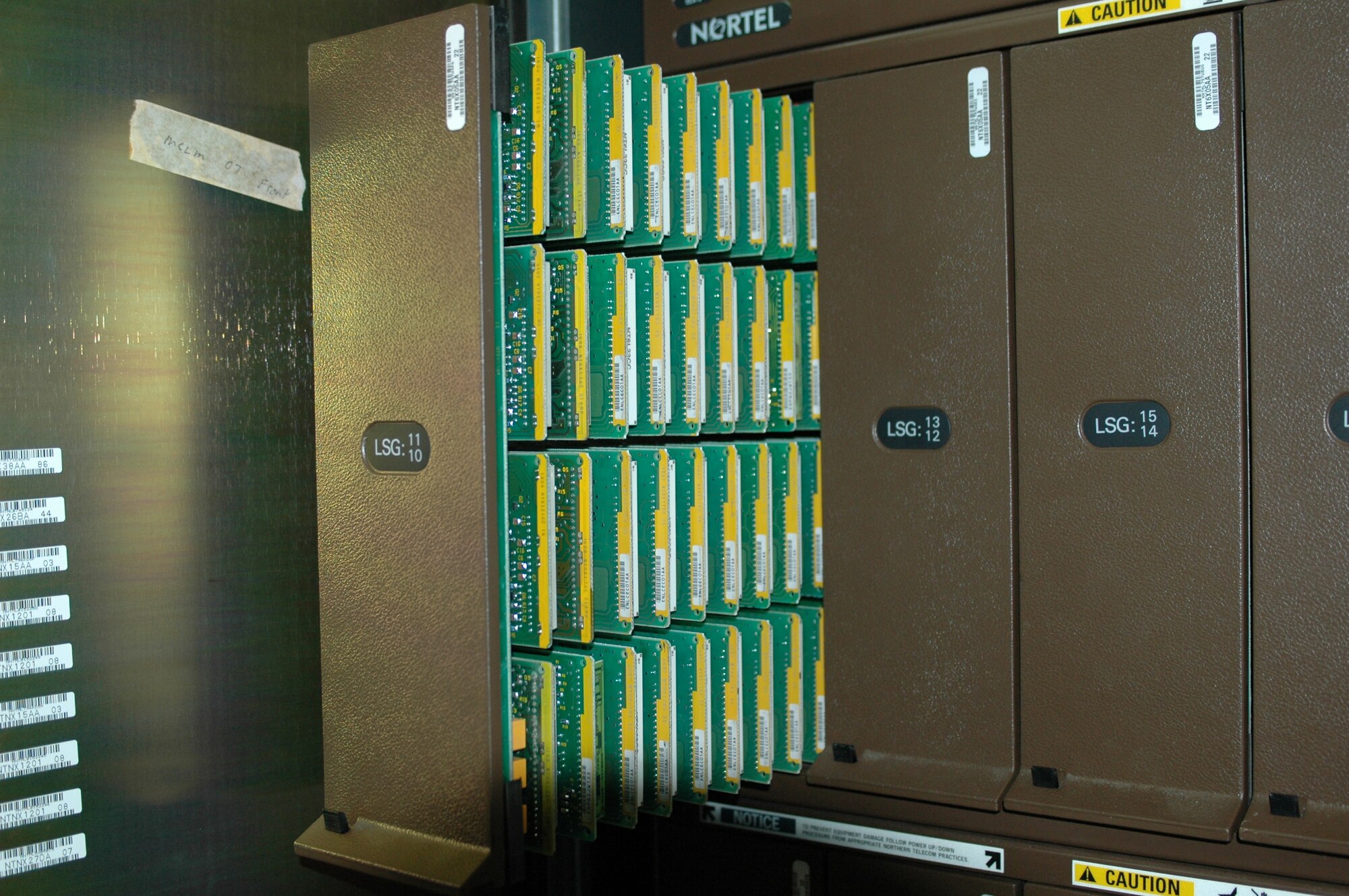 A trunk of phone cards is pulled from its storage area. The office has adopted several new technologies, including one which automatically protects the base against unauthorized faxes and war dialers. (U.S. Air Force photo/Nick DeCicco)