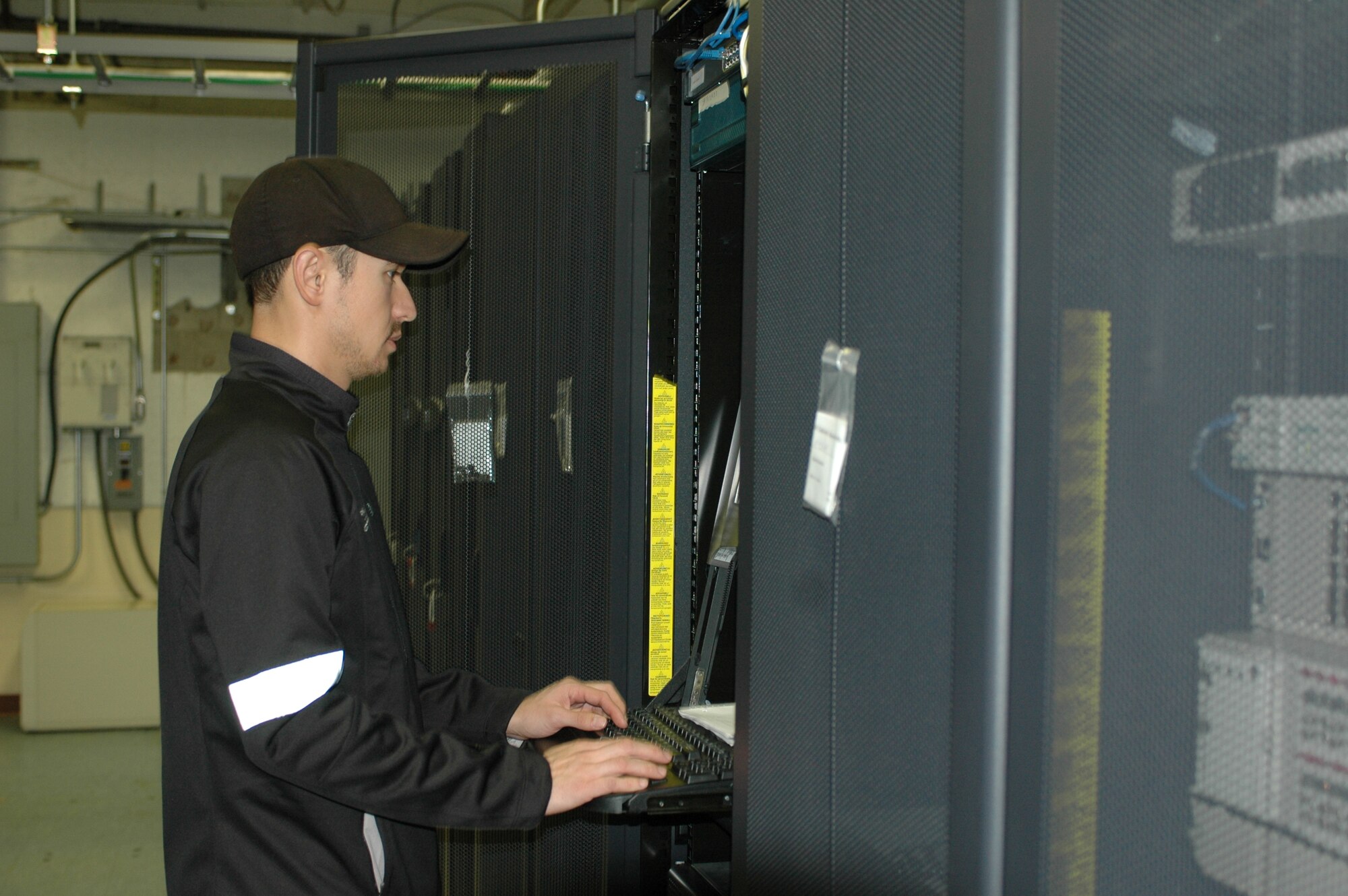 Aurora Group Telecommunications employee Rich Blink works at a computer involved in the operation of the base’s voicemail system. The telephone systems office is in the process of switching from the 30-year-old Meridian voicemail system to the newer, digital Callegra format. (U.S. Air Force photo/Nick DeCicco)
 
