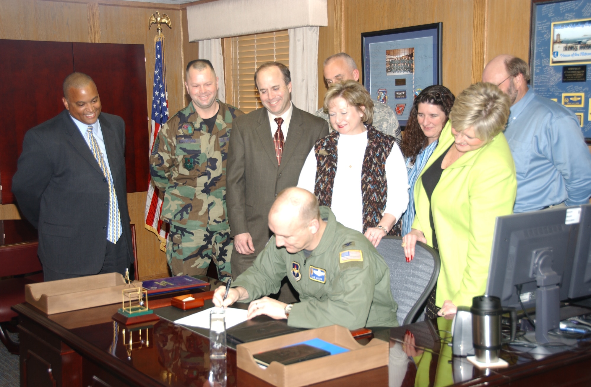 ALTUS AIR FORCE BASE, Okla. -- Base personnel and local bank representatives look on as Col. David W. Allvin, 97th Air Mobility Wing commander, signs the Military Saves proclamation Feb. 11. (U.S. Air Force photo/Senior Clinton Atkins)
