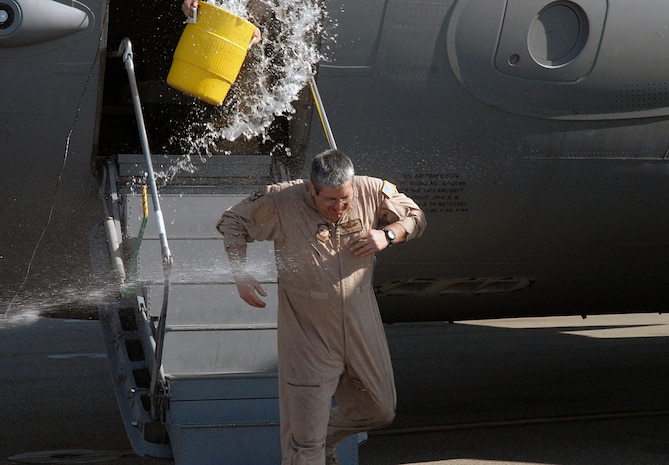 Chief Master Sgt. Paul Zukoski, 437th Operations Group, gets water thrown on him by a crew member and sprayed with a hose after completion of his "Fini Flight" Feb. 9 on the Charleston AFB flightline. During his military career, Chief Zukoski has accumulated more than 10,000 flying hours and will be retiring from the Air Force Feb. 29. (U.S. Air Force photo/Master Sgt. Paul Kilgallon)
