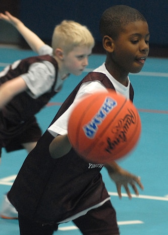Nicholas Tolbert, 7, of the Charleston Jaguars, son of Chief Petty Officer Gene Tolbert, catches a rebound shot and dribbles down toward his basket at the Charleston AFB 7- to 8-year-old game Saturday at the Youth Center. (U.S. Air Force photo/Master Sgt. Paul Kilgallon)