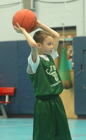 Chase Bruno, 7, of the Charleston Clovers, son of Michael Bruno, looks for an open player before passing the ball at the Charleston 7- to 8-year-old game Saturday at the Youth Center. (U.S. Air Force photo/Master Sgt. Paul Kilgallon)