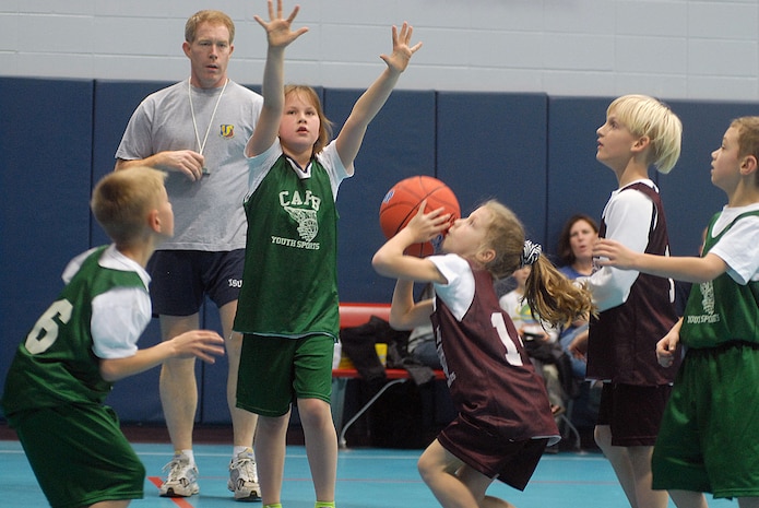 Alyssa Butters, 9, of the Charleston Clovers, daughter of Col. Anthony Butters, tries to block a Jaguars players shot, during the Charleston AFB 7- to 8-year-old game Saturday at the Youth Center. (U.S. Air Force photo/Master Sgt. Paul Kilgallon)