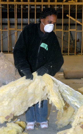 Tech. Sgt. Lasonja Murray, 315th Logistics Readiness Flight, handles old sections of insulation and places them into a large pile to be disposed of Feb. 8, at the Top 3-sponsored Habitat for Humanity project in Summerville, S.C. (U.S. Air Force photo/Master Sgt. Paul Kilgallon)
