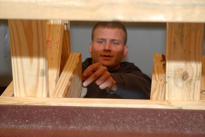 Staff Sgt. Nathan Babb, 437th Maintenance Squadron, ensures he has a piece of wood lined up before hammering it into place Feb. 8 at the Top 3-sponsored Habitat for Humanity project in Summerville, S.C. (U.S. Air Force photo/Master Sgt. Paul Kilgallon)