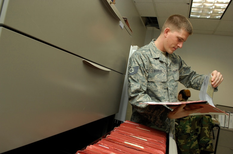 Technical Sgt. Richard Burch, 612th Air Comunications Squadron unit deployment manager, performs a training record review on upcoming deploying personnel Feb. 5. (U.S. Air Force photo by Senior Airman Jesse Shipps)