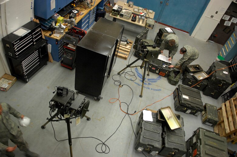 Technical Sgt. Jonathan Graham and Tech. Sgt. John Hickey, both 612th ACOMS quality assurance inspectors, perform an inspection of Tropo Satellite Support Radios, which are line of sight radio communication devices that send information wirelessly from one to another. (U.S. Air Force photo by Senior Airman Jesse Shipps)