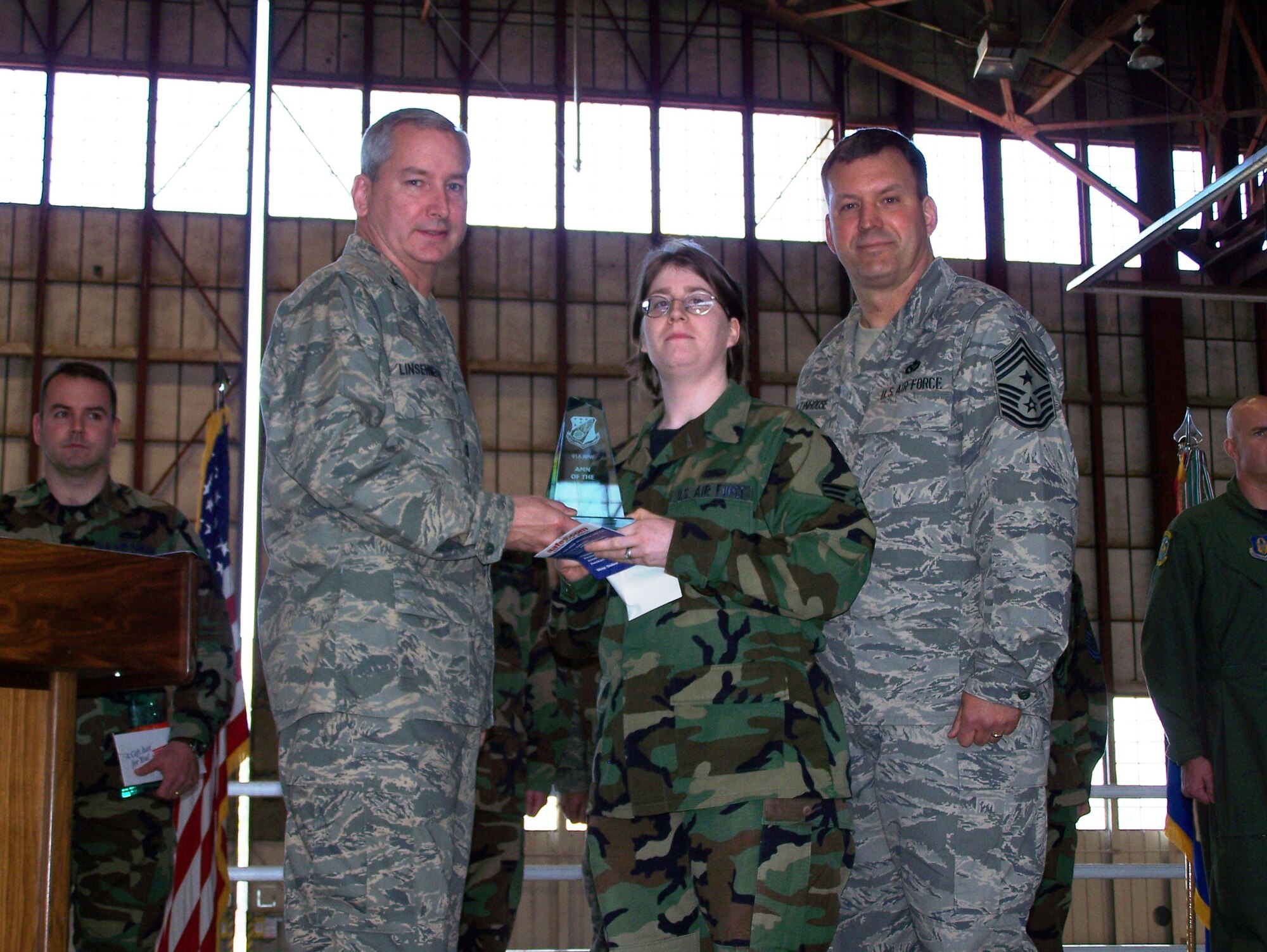 SEYMOUR JOHNSON AIR FORCE BASE, N.C.-- Senior Airman Elizabeth Carr (middle) receives the Airman of the Quarter Award for Oct-Dec 2007. Col. Fritz Linsenmeyer (left), wing commander and Command Chief Master Sgt. Lester Boltinhouse present the award. Airman Carr is a reservist with the 916th Communications Squadron. U.S. Air Force photo/Tech. Sgt. Ian Gardner