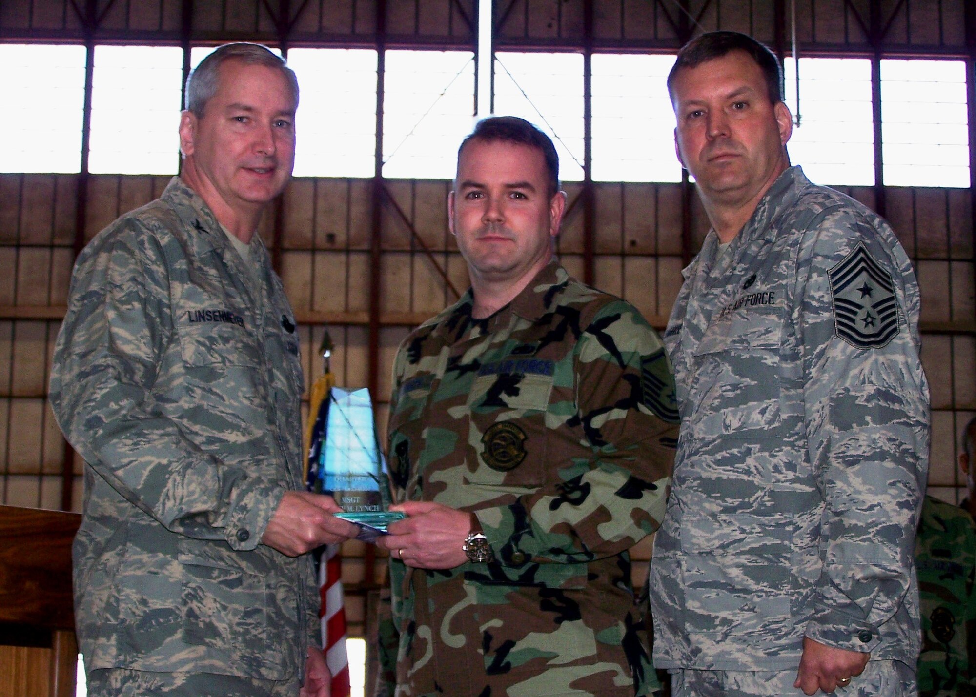SEYMOUR JOHNSON AIR FORCE BASE, N.C.-- Master Sgt. Shane Lynch (middle) receives the Senior Noncommissioned Officer of the Quarter Award for Oct-Dec 2007. Col. Fritz Linsenmeyer (left), wing commander and Command Chief Master Sgt. Lester Boltinhouse present the award. Sgt. Lynch is a reservist with the 916th Communications Squadron. U.S. Air Force photo/Tech. Sgt. Ian Gardner