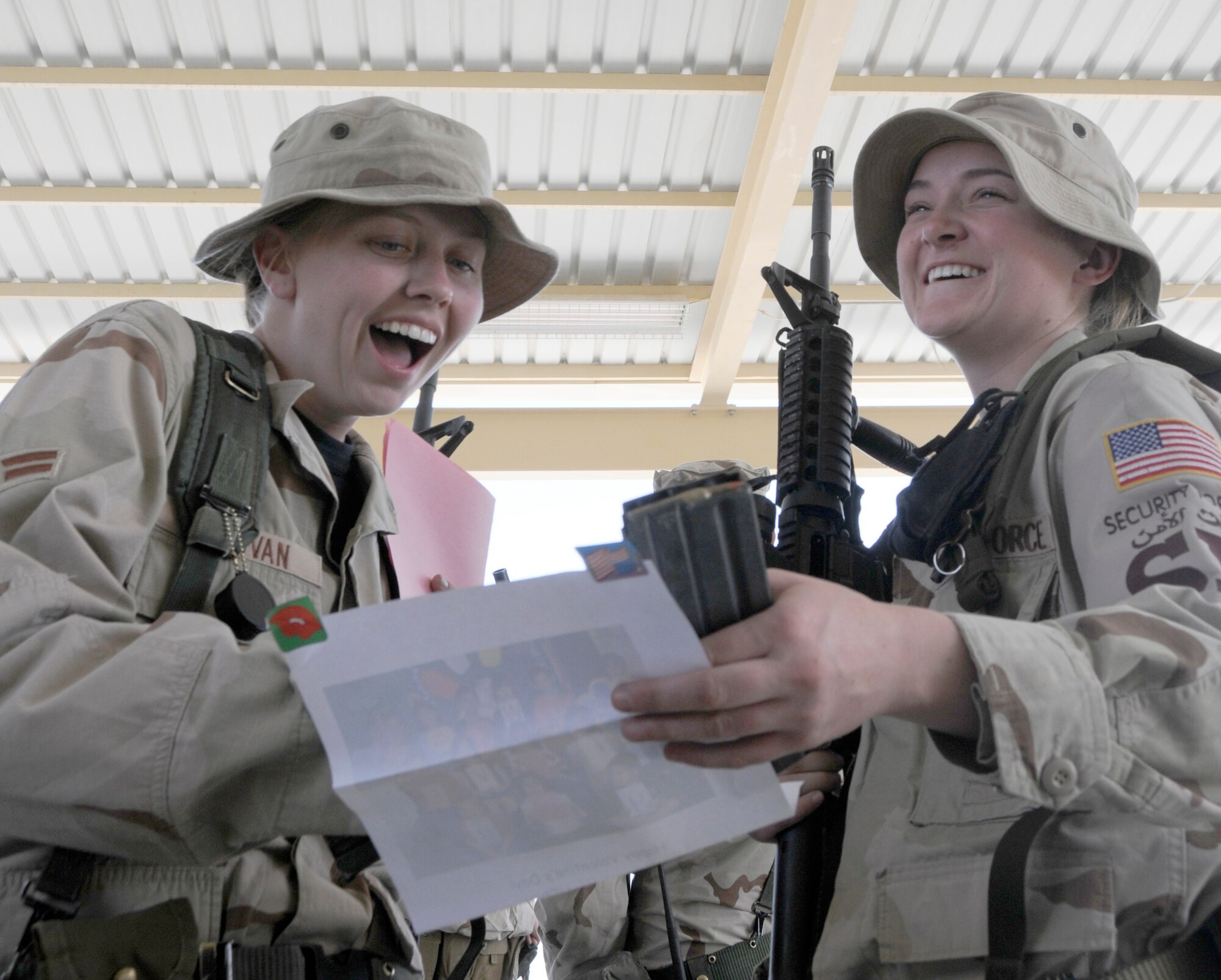 SOUTHWEST ASIA -- Airmen 1st Class Kathleen Sullivan and Lindsay Judkins, 379th Expeditionary Security Forces members, are surprised to receive Valentines from Texas elementary school students Feb. 13. Children from Merkel, Tye, and Trent sent more than 300 Valentines greetings Southwest Asia this year, thanking Airmen for their service and for keeping America free. Both are deployed from Schriever Air Force Base, Colo. (U.S. Air Force photo/Senior Airman Domonique Simmons