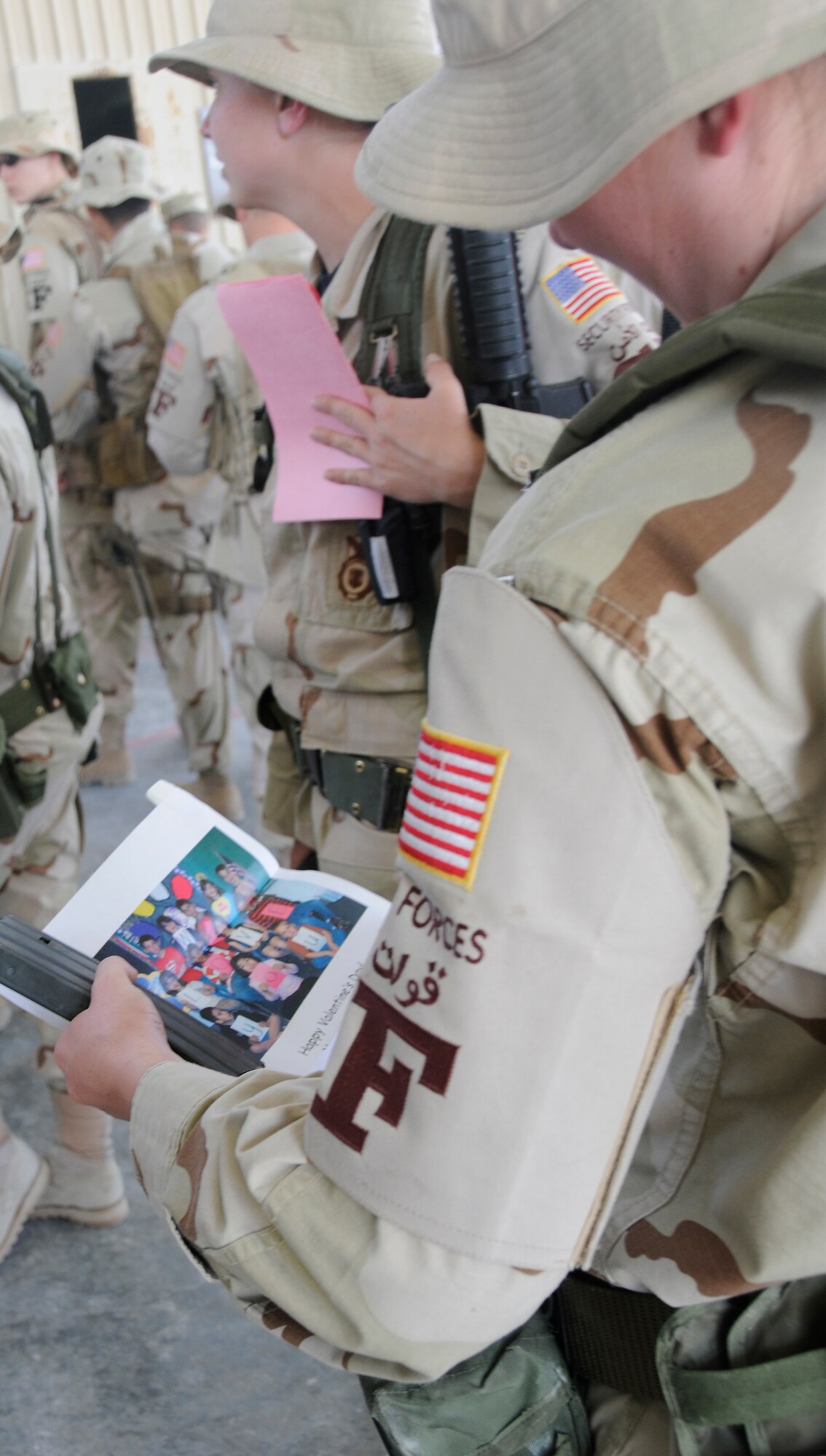 SOUTHWEST ASIA -- A 379th Expeditionary Security Forces Squadron member reads a Valentine from Merkel Elementary School students during a surprise "Be My Valentine" event Feb. 13. Students from Merkel, Ty, and Trent schools mailed more than 300 Valentines cards to the 379th Air Expeditionary Wing in support and appreciation of deployed servicemembers. Cards were distributed to Airmen deployed to the base as well as to wounded warriors at the base medical clinic. "By serving, you're doing a big act of love," one card read. "So we want you to know we love you, too." (U.S. Air Force photo/Senior Airman Domonique Simmons) 