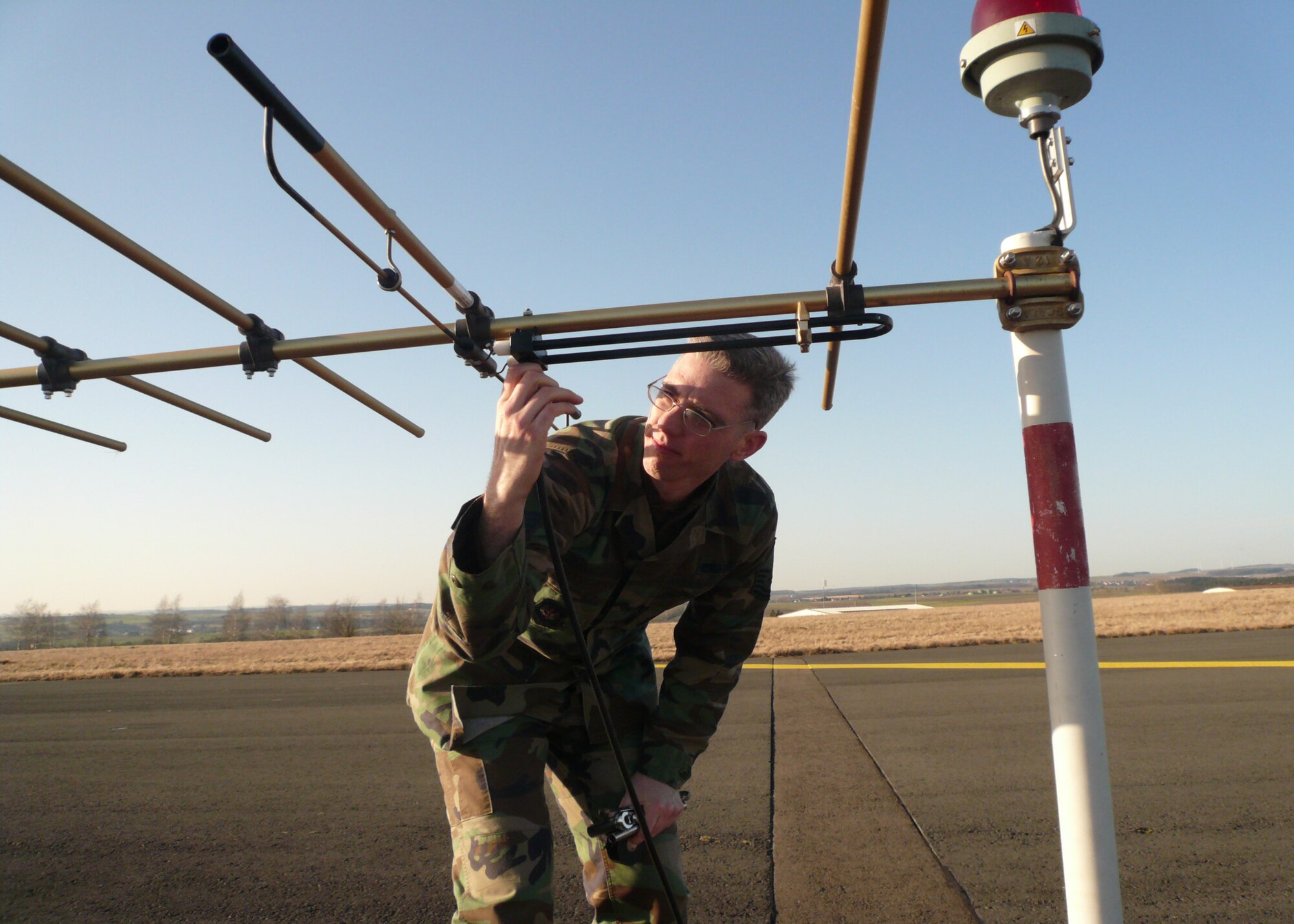 SPANGDAHLEM AIR BASE, Germany – Master Sgt. Jeff Dawson, 52nd Communications Squadron, reinstalls an Instrument Landing System near field monitor antenna. Sergeant Dawson is the section chief of the air traffic control and landing systems shop. (U.S. Air Force photo/Airman 1st Class Steven McKee)
