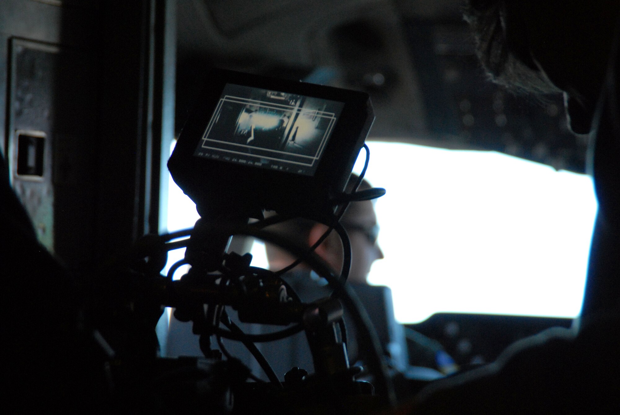 A film crew aboard a KC-10 Extender from Travis Air Force Base, Calif., films Maj. Ian Larive, the KC-10 aircraft commander, and his flight crew as they fly the aircraft over the skies of Edwards Air Force Base, Calif., on Feb. 7. Film crews were at Edwards Feb. 6 to 8 to film one of three new Air Force commercials set to debut later this year. (Air Force Photo by Master Sgt. Eric M. Grill)