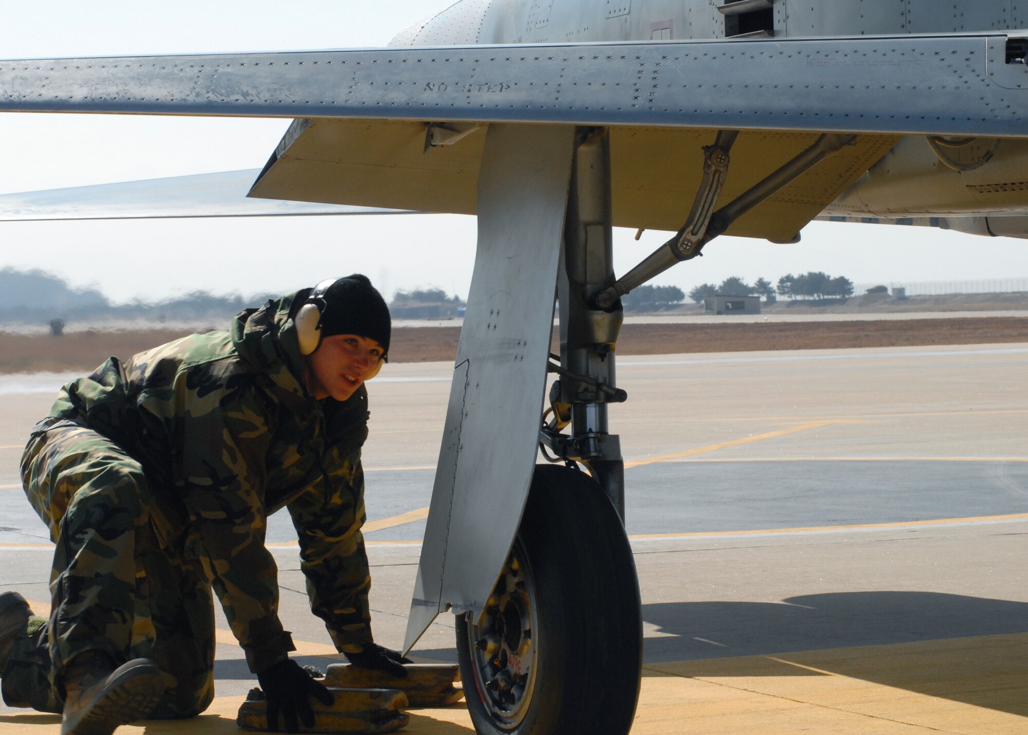 KUNSAN AIR BASE, South Korea— Senior Airman Tyler Brown, 8th Maintenance Group weapons, chalks a Republic of Korea Air Force F-5 here Feb. 13. This event was a part of cross servicing aircraft for training purposes by the ROKAF and the 8th Fighter Wing.  (U.S. Air Force Photo/Staff Sgt Araceli Alarcon) 
