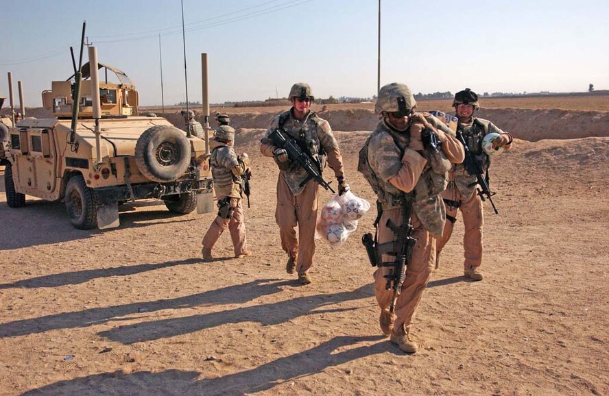 CAMP BUCCA, Iraq – Airmen from the 887th Expeditionary Security Forces Squadron deliver a load of soccer balls to a school near Umm Quasr, Iraq, Feb. 7, 2008. The donation is part of an area-wide effort near Camp Bucca to aid the surrounding citizens in maintaining their newly returned province. Al-Basra became the ninth province in Iraq to be transitioned to Iraqi provincial control in January. (U.S. Army photo/Spc. Brandon Hubbard, 300th MP BDE)