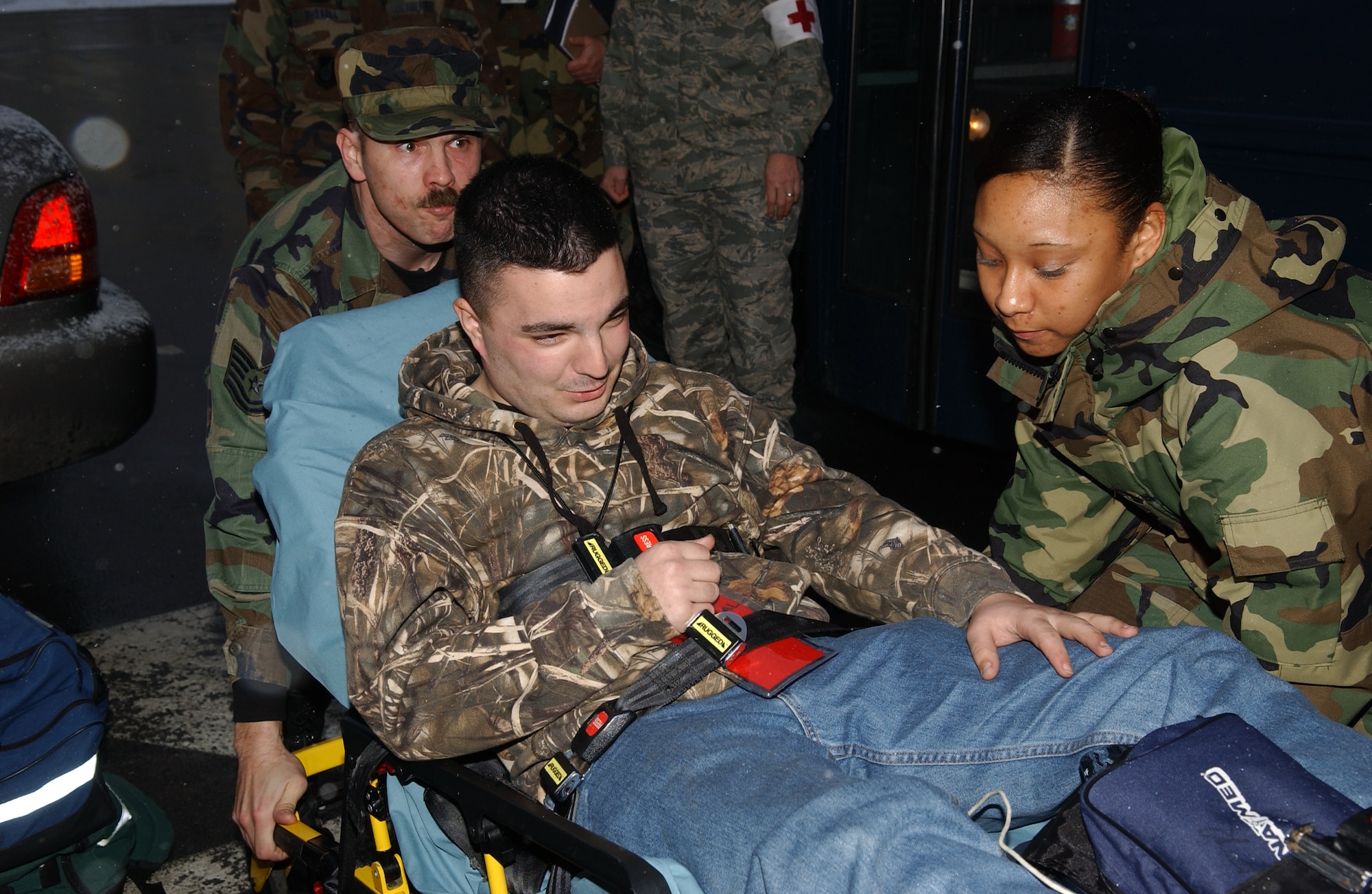 MISAWA AIR BASE, Japan -- Medical technicians from the primary response team prepare Airman 1st Class Robert Sinyard, a simulated injured evacuee, for travel in an ambulance during the Initial Readiness Response Exercise here on Feb. 12, 2008.  As part of the exercise, Misawa personnel practiced noncombatant evacuation operations. (U.S. Air Force photo by Senior Airman Robert Barnett)