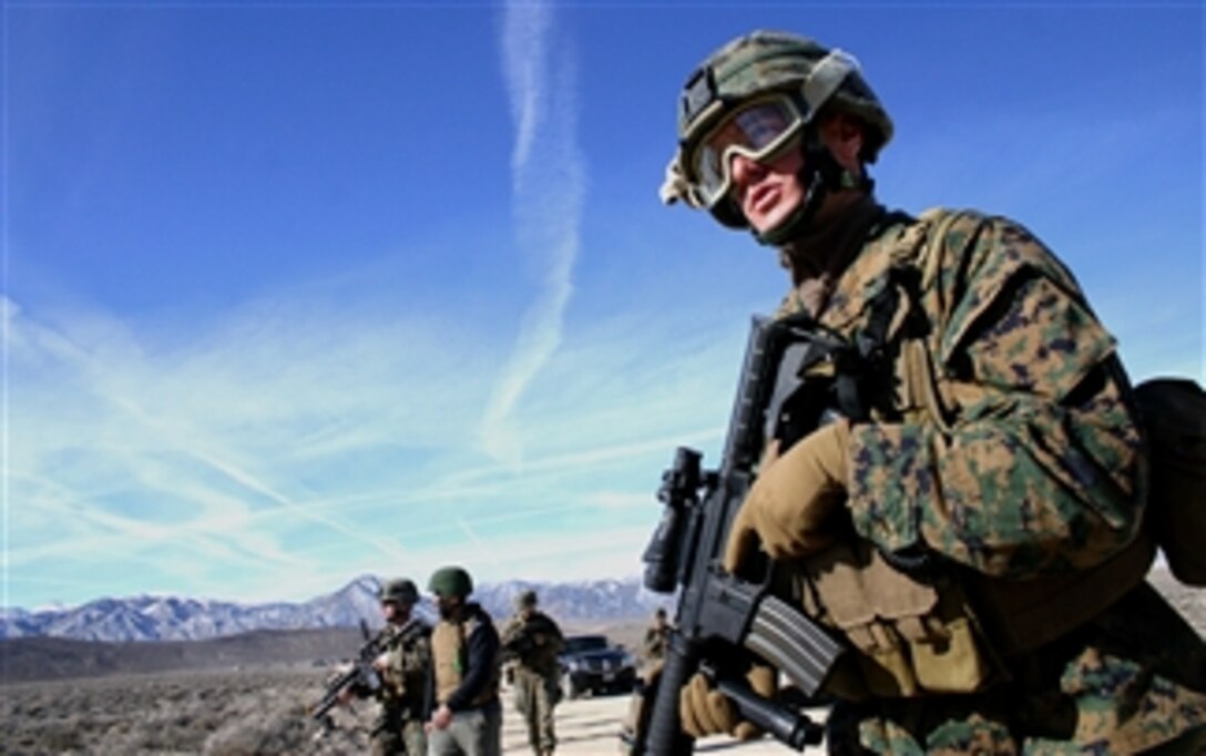 A U.S. Marine keeps his eyes peeled during a patrol  in an urban terrain training facility in Hawthorne, Nev., Feb. 9, 2008. His team, serving under 3rd Marine Division, will deploy to Afghanistan where they will train and advise the Afghan National Army to become a self-efficient military force. 