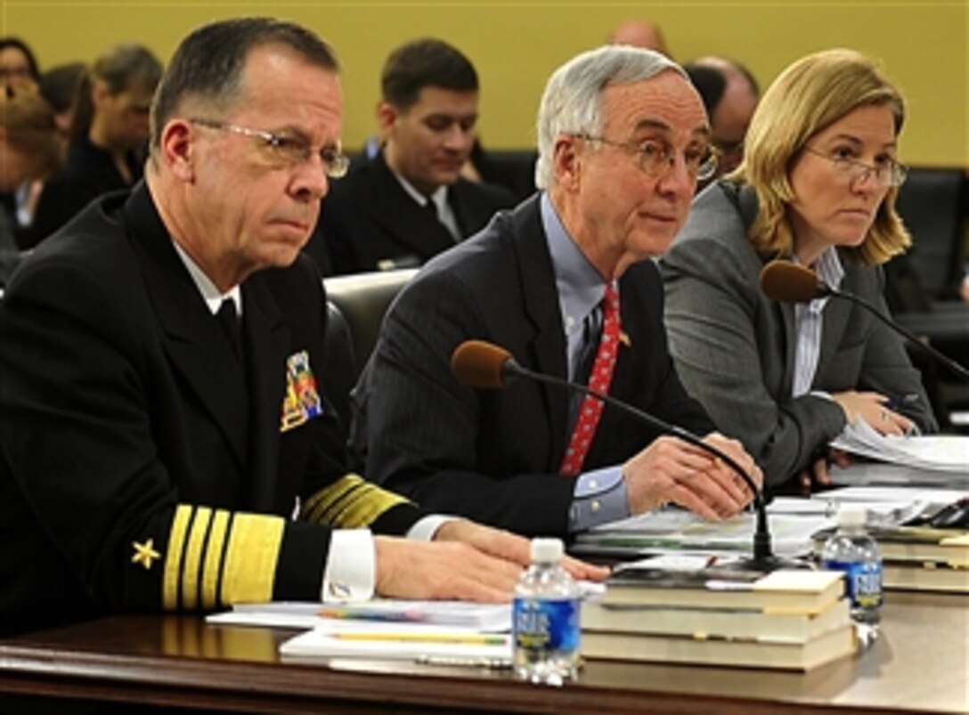Navy Adm. Michael G. Mullen, left, chairman of the Joint Chiefs of Staff, responds to a question during a hearing before the House Appropriations Subcommittee on Defense. Next to Mullen is Deputy Defense Secretary Gordon England, center, and Defense Department Comptroller Tina Jonas, right, who also testified, Feb. 13, 2008.  