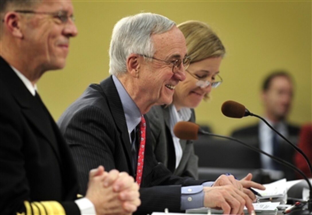 Deputy Secretary of Defense Gordon England (center) shares a lighter moment as he testifies along with Chairman of the Joint Chiefs of Staff Adm. Mike Mullen (left), U.S. Navy, and Under Secretary of Defense (Comptroller) and Chief Financial Officer Tina Jonas at the House Appropriations Committee hearing at the Rayburn office building in Washington, D.C., on Feb. 13, 2008.  