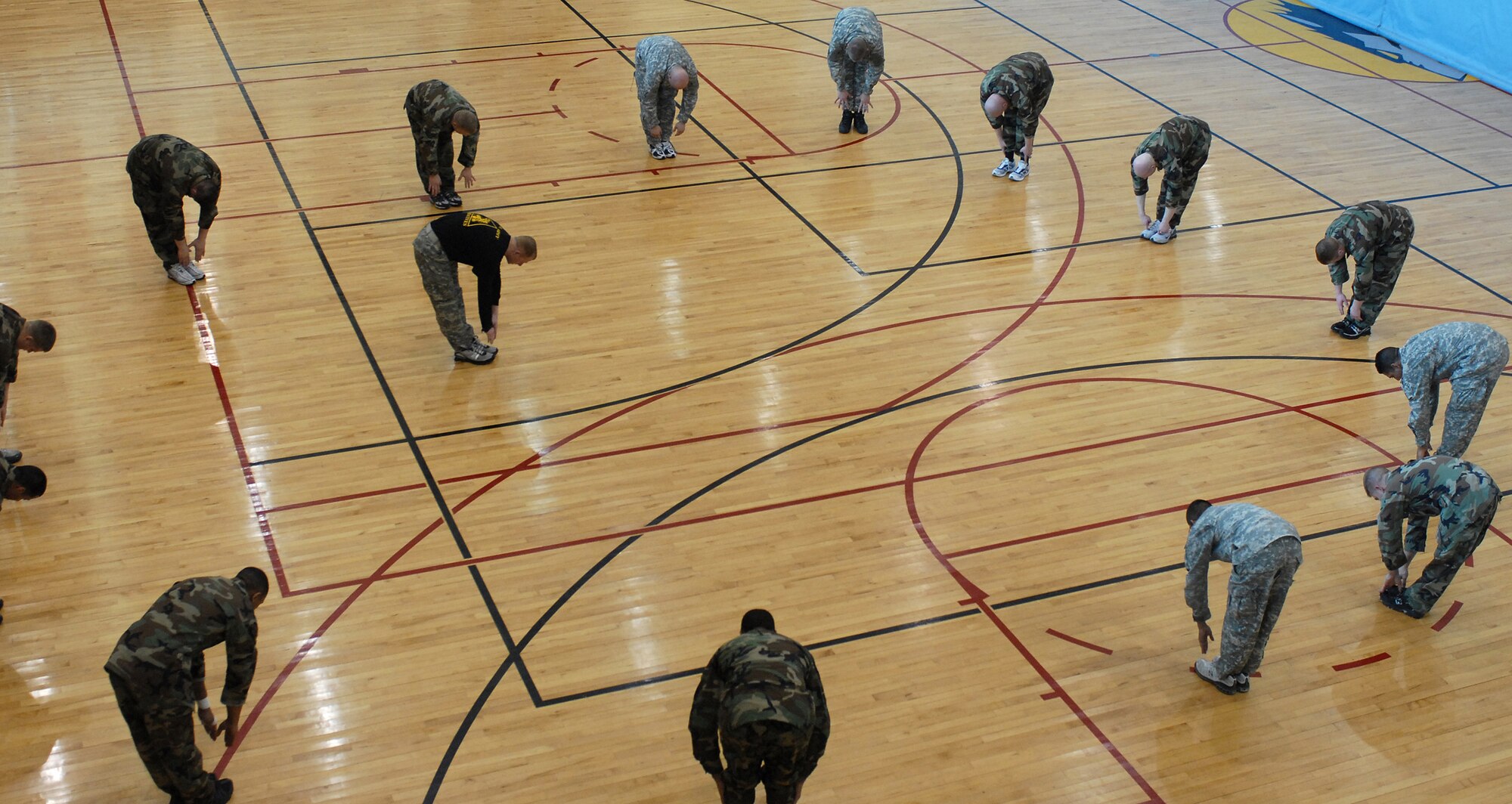 KUNSAN AIR BASE, South Korea -- Airmen and Soldiers go through stretching exercises before entering a hand-to-hand combat tournament here Feb. 14.  This training is part of the Army warrior ethos. The training is now offered to Airmen here to enhance mission effectiveness between the two services. The Air Force is currently working on a service specific hand-to-hand combat training for all Airmen. Currently, the Air Force's Officer Training School has implemented a new close-combat course into its curriculum.  (U.S. Air Force photo/Senior Airman Giang Nguyen)
