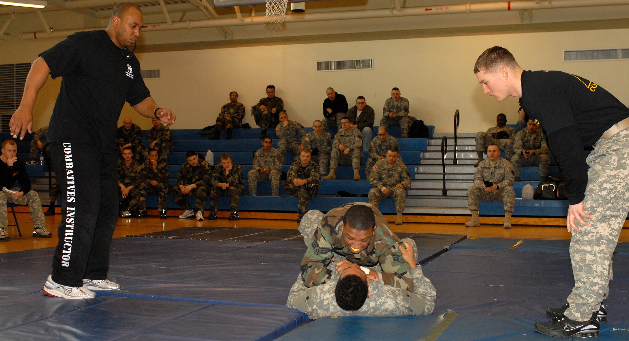 KUNSAN AIR BASE, South Korea -- Senior Airman Tesfaya Campbell, 8th Security Forces Squadron, and Private First Class Grayson Damon, 144th Charlie Company Air and Missile Defense, engage in hand-to-hand combat here Feb. 14.  The training is part of the Army warrior ethos. The training is now offered to Airmen here to enhance mission effectiveness between the two services. The Air Force is currently working on a service specific hand-to-hand combat training for all Airmen. Currently, the Air Force's Officer Training School has implemented a new close-combat course into its curriculum.   (U.S. Air Force photo/Senior Airman Giang Nguyen)