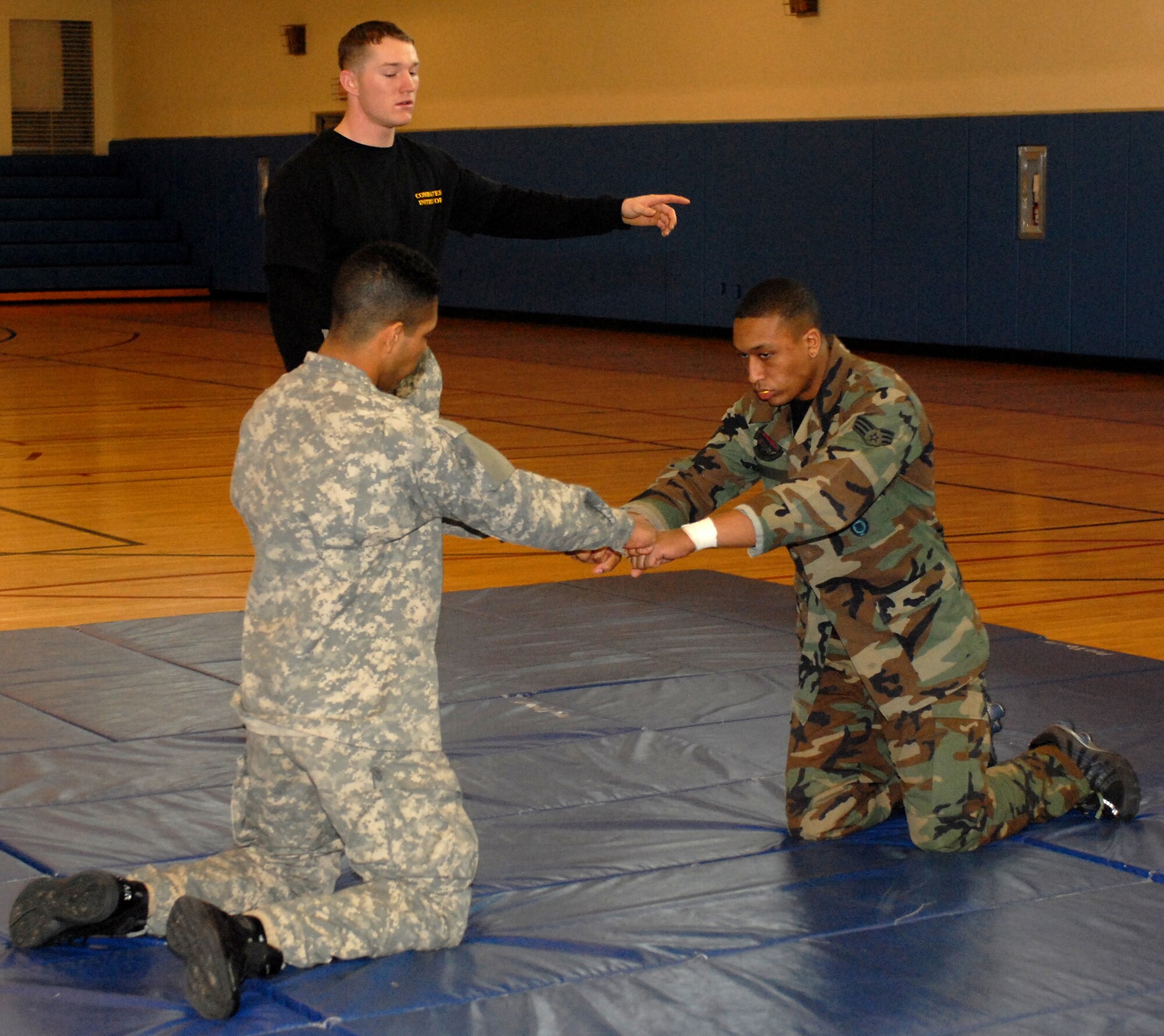 KUNSAN AIR BASE, South Korea --  Senior Airman Tesfaya Campbell, 8th Security Forces Squadron, and Private First Class Grayson Damon, 144th Charlie Company Air and Missile Defense, prepare for hand-to-hand combat here Feb. 14. The training is part of the Army warrior ethos. The training is now offered to Airmen here to enhance mission effectiveness between the two services. The Air Force is currently working on a service specific hand-to-hand combat training for all Airmen. Currently, the Air Force's Officer Training School has implemented a new close-combat course into its curriculum.  (U.S. Air Force photo/Senior Airman Giang Nguyen)