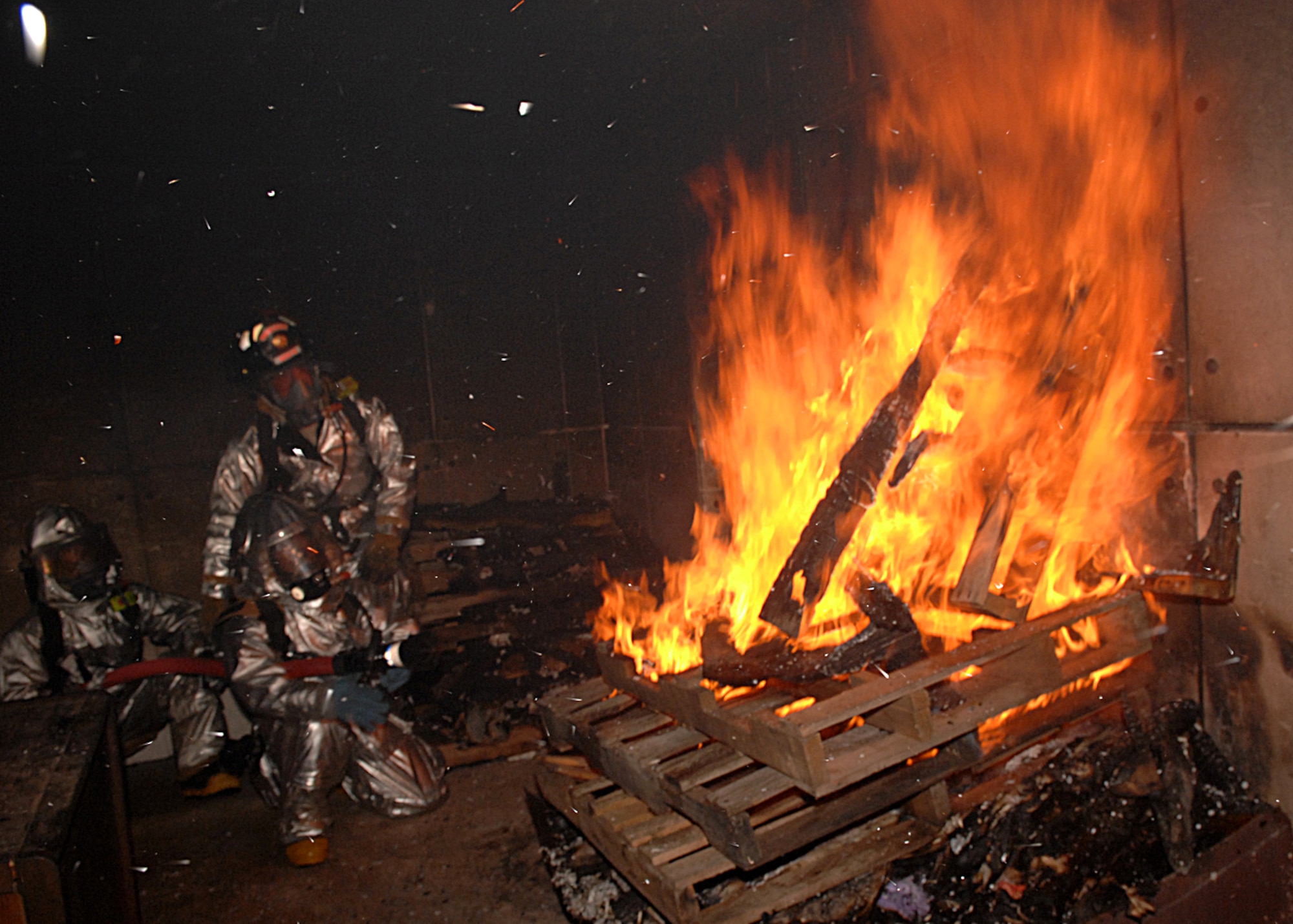 Andersen AFB, Guam -- Fire fighters with the 36th Civil Engineer Squadron practice their skills by putting out actual fires. Andersen's fire department trains every day to respond to emergencies 24 hours a day, seven days a week.
(U.S. Air Force Photo By Staff Sgt. Vanessa Valentine)