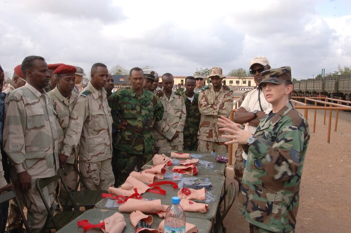 DJIBOUTI—Tech. Sgt. Traci Wilmoth, 99th Medical Group, Nellis Air Force Base, Nev., explains how to treat specific injuries during a medical information exchange practical exercise here Jan. 16. Medical personnel from Army Forces Central Command, U.S. Central Command Air Forces and Combined Joint Task Force-Horn of Africa took part in demonstrating basic medical techniques to the Djiboutian national army soldiers. (U.S. Navy photo by Mass Communication Specialist 1st Class Mary Popejoy) 
