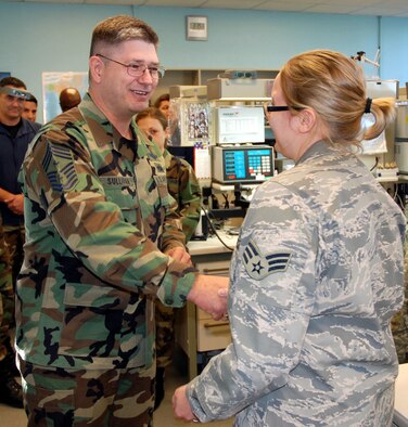 PETERSON AIR FORCE BASE, Colo. -- Chief Master Sgt. Michael Sullivan, command chief for Air Force Space Command, visits with members of the 21st Space Wing. He gave his chief's coin to Senior Airman Megan Hein, 721st Security Forces Squadron, to recognize her superior performance. (U.S. Air Force photo by Senior Airman Stephen Collier)