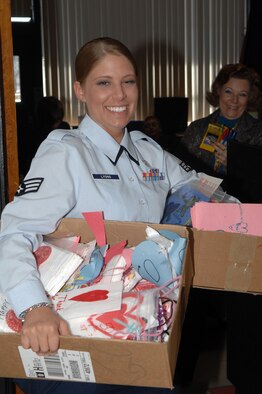 BARKSDALE AIR FORCE BASE, La. - Senior Airman Sarah Lyons carries boxes of Valentine’s Day cards out of a classroom at Waller Elementary School on February 8, 2008. The valentines and candy bags were made by 3rd grade students for Airmen at Barksdale Air Force Base who live in the dorms that will be away from their families on Valentine’s Day. (U.S. Air Force photo by Airman 1st Class Joanna M. Kresge)
