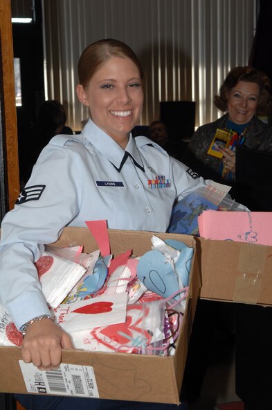 BARKSDALE AIR FORCE BASE, La. - Senior Airman Sarah Lyons carries boxes of Valentine’s Day cards out of a classroom at Waller Elementary School on February 8, 2008. The valentines and candy bags were made by 3rd grade students for Airmen at Barksdale Air Force Base who live in the dorms that will be away from their families on Valentine’s Day. (U.S. Air Force photo by Airman 1st Class Joanna M. Kresge)
