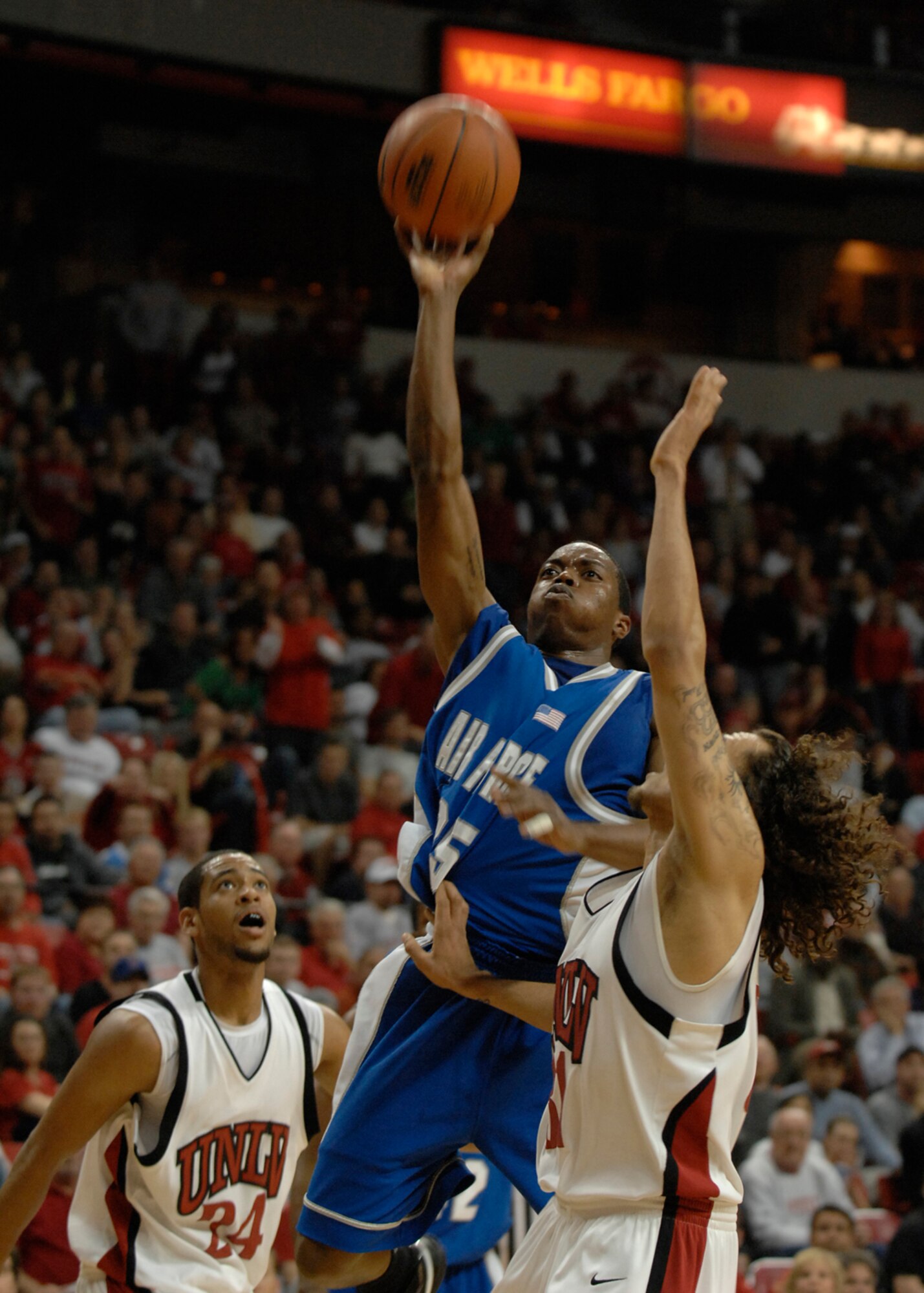 LAS VEGAS—Air Force Academy Falcons guard, Evan Washington, verticals over a University of Nevada Las Vegas defender during a Mountain West Conference match-up at the Thomas and Mack Center here Feb. 12. Washington scored 11 points for the night. The Falcons trailed the Rebels 51-58 at game’s end. The loss drops the Falcons to 12-11 for the season with a 4-6 conference record. (U.S. Air Force photo by Airman 1st Class Brian Ybarbo)
