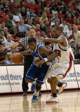 LAS VEGAS— Air Force Academy Falcons guard, Anwar Johnson, dribbles past University of Nevada Las Vegas Rebel, Wink Adams, during a Mountain West Conference match-up at the Thomas and Mack Center here Feb. 12. Johnson put up one assist, one block and two steals for the night. The Falcons trailed the Rebels 51-58 at game’s end. The loss drops the Falcons to 12-11 for the season with a 4-6 conference record. (U.S. Air Force photo by Airman 1st Class Brian Ybarbo)