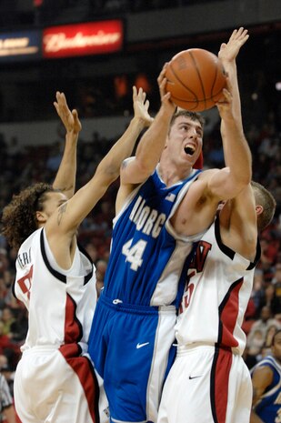 LAS VEGAS—Air Force Academy Falcons forward, Keith Maren, splits two University of Nevada Las Vegas defenders during a Mountain West Conference match-up at the Thomas and Mack Center here Feb. 12. Maren lead the game in total rebounds with 8 for the night. The Falcons trailed the Rebels 51-58 at game’s end. The loss drops the Falcons to 12-11 for the season with a 4-6 conference record. (U.S. Air Force photo by Master Sgt Robert W. Valenca)