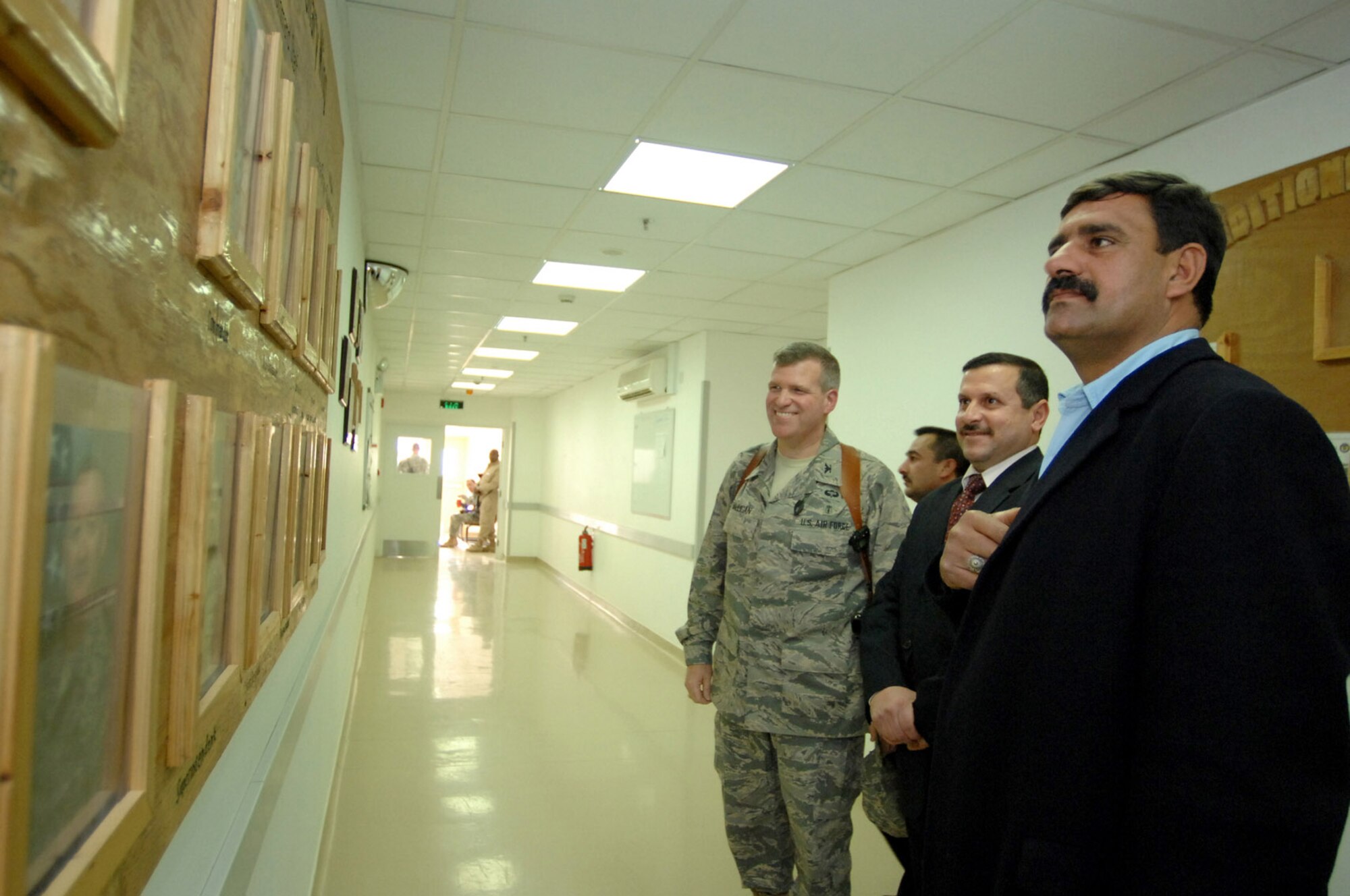 Local leaders from the city of Balad tour the Air Force Theater Hospital accompanied by Col. Timothy Halligan (left) Feb. 11 at Balad Air Base, Iraq. The men came to the hospital to visit Iraqi patients who were injured the previous day by a vehicle-borne improvised explosive device. Colonel Halligan is the 332nd Expeditionary Medical Group deputy commander and deployed from Lackland Air Force Base, Texas. (U.S. Air Force photo/Senior Airman Julianne Showalter) 
