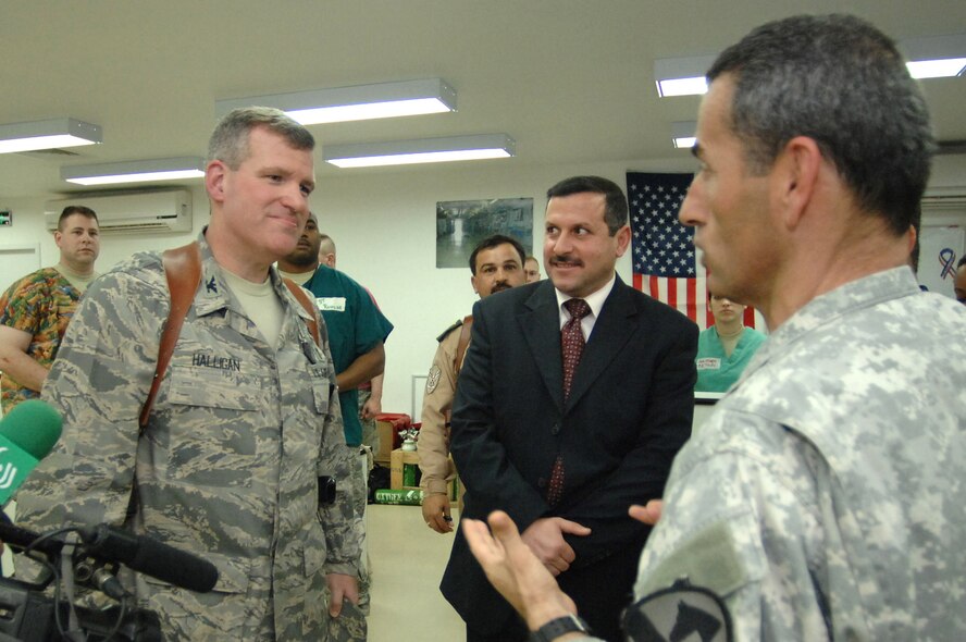 Col. Timothy Halligan speaks with city of Balad Mayor Amer Mrhown Al-Obedy (center) through a translator about the importance of training Iraqi doctors to eventually take the helm at the Air Force Theater Hospital Feb. 11 at Balad Air Base, Iraq. Colonel Halligan is the 332nd Expeditionary Medical Group deputy commander and deployed from Lackland Air Force Base, Texas. (U.S. Air Force photo/Senior Airman Julianne Showalter) 