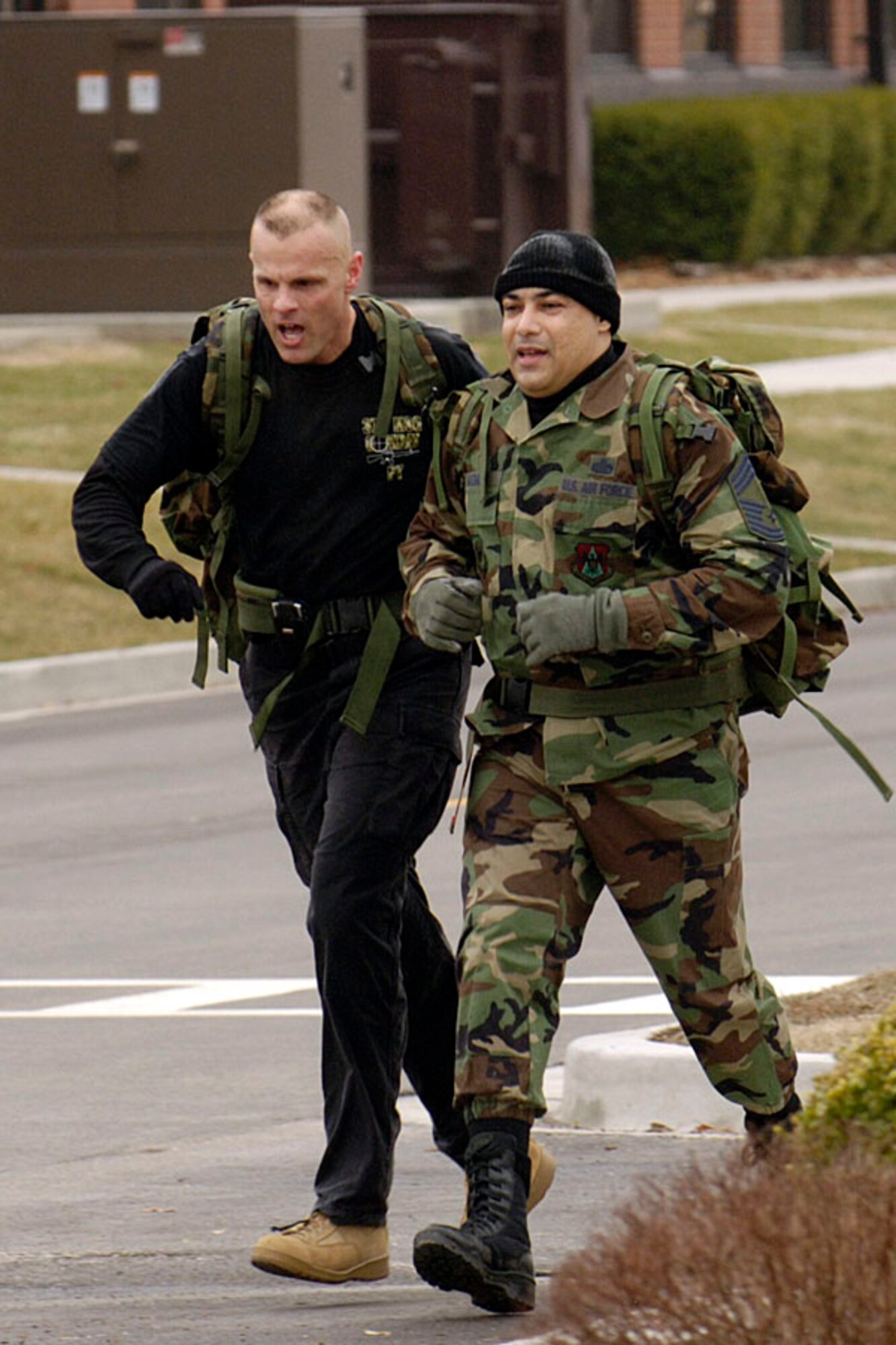 SCOTT AIR FORCE BASE, Ill. -- Col. Brad Spacy, 375th Mission Support Group commander (left), and Chief Master Sgt. Jose Guzman, 375th MSG command chief, work as a team to finish the ruck march during the MSG Warfighter Day Feb 7. (U.S. Air Force photo/Senior Airman Jonathan Lovelady)