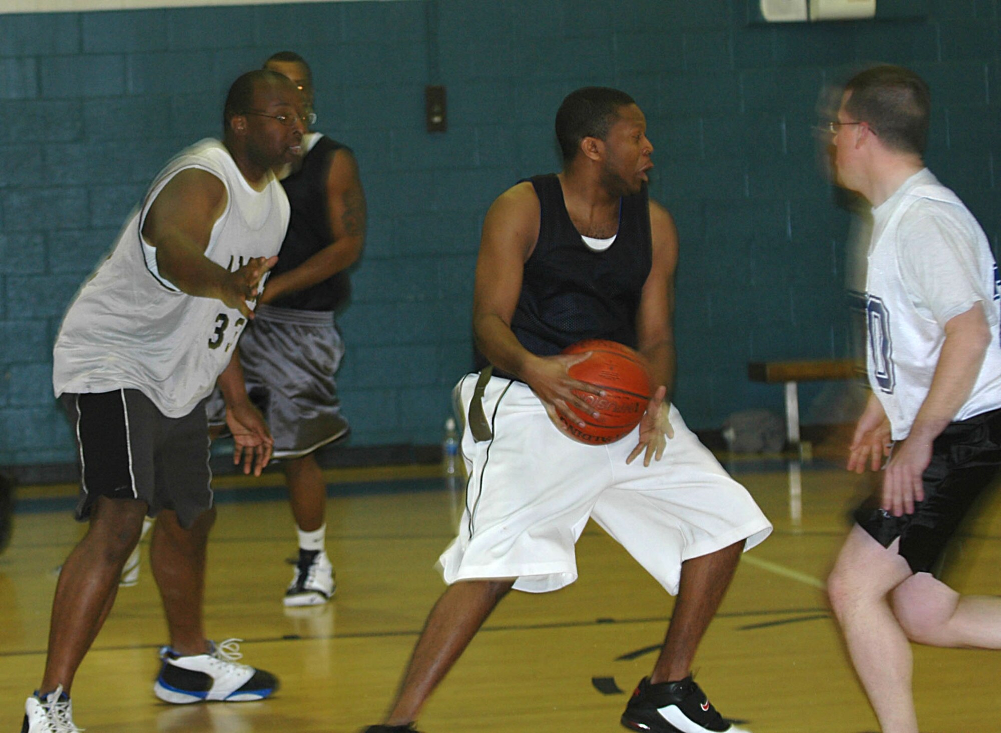 The 512th Mission Support Squadron's Ernest Davis grabs a rebound and looks for a way out during the Dover Intramural Basketball game against the 736th Aircraft Maintenance Squadron Jan. 22.  The 512th MSS team, comprised of personnel and family members assigned to the 512th Airlift Wing, won the game 68-29 and are currently 7-0 in the league. (U.S. Air Force photo\Senior Airman Sasha Skrine)