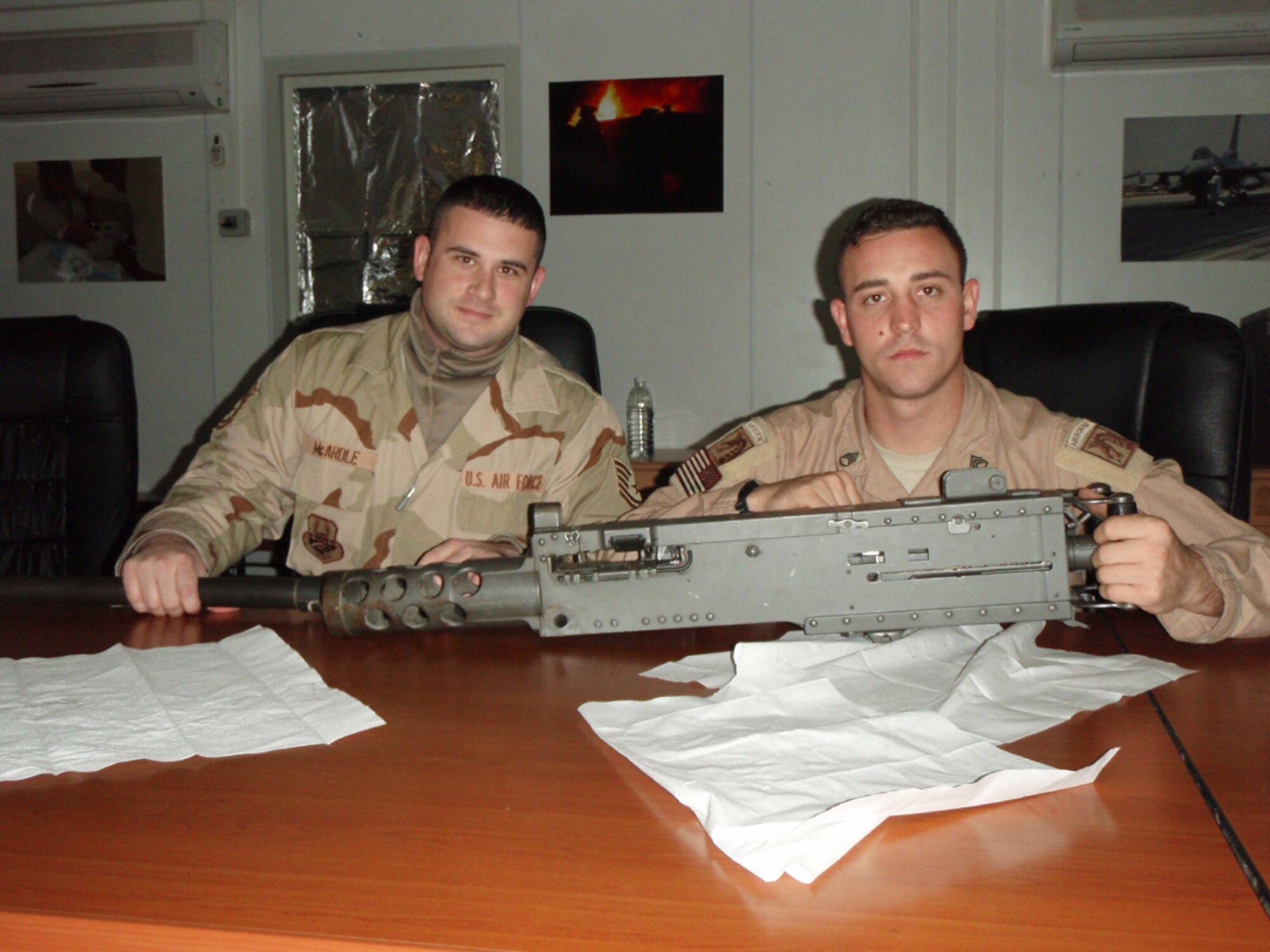 SEYMOUR JOHNSON AIR FORCE BASE, N.C. -- Tech. Sgt. Chris McArdle (left) gets some training on a .50 calibur weapon from an Army sergeant. Sgt. McArdle, a reservist with the 916th Civil Engineer Squadron, is currently deployed to Balad, Iraq.