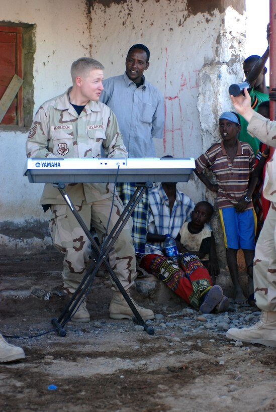 Technical Sgt. Jonathan McPherson performs for members of a local community in Nagad, Djibouti. Sergeant McPherson is the keyboardist for The U.S. Air Force Band's Silver Wings, which participated in a 55-day deployment to six countries throughout Southwest Asia and Africa as part of the U.S. Central Command Air Forces' Expeditionary Band Live Round.