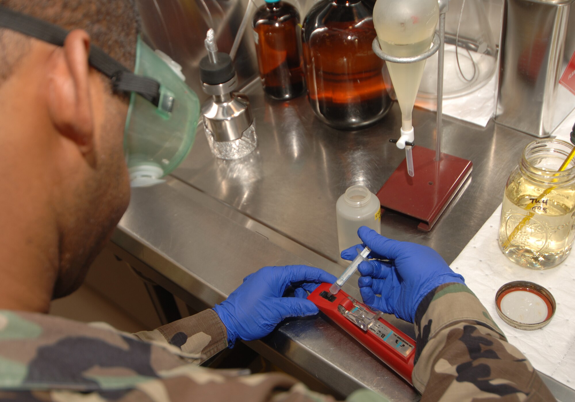 MOODY AIR FORCE BASE, Ga. – Staff Sgt. Ruben Watson, 23rd Logistics
Readiness Squadron fuels lab technician, puts distilled water into a refractometer to calibrate it before its use here Feb 6. The refractometer is used to measure Fuel System Icing Inhibitor content in Jet Fuel. (U.S. Air Force photo by Senior Airman Schelli Jones)
