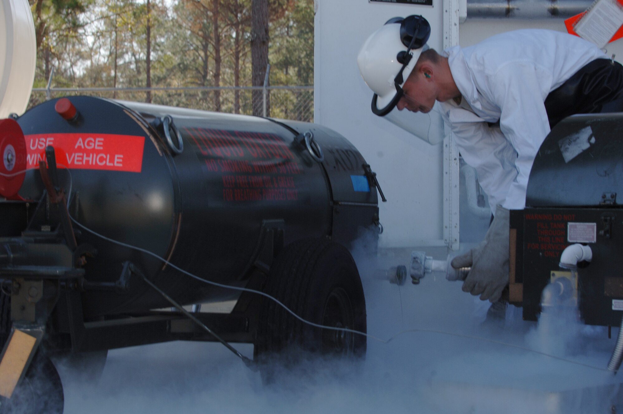 MOODY AIR FORCE BASE, Ga. – Airman 1st Class Tyler Pillmore, 23rd
Logistics Readiness Squadron storage operator, disconnects a 55 gallon liquid oxygen cart after filling it from the base LOX tanks here Feb 5. LOX is converted to aviators breathing oxygen for aircrews to breathe at high altitudes. (U.S. Air Force photo by Senior Airman Schelli Jones)
