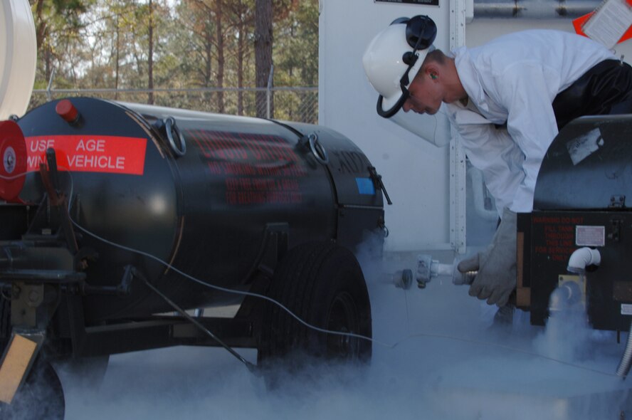 MOODY AIR FORCE BASE, Ga. – Airman 1st Class Tyler Pillmore, 23rd Logistics Readiness Squadron storage operator, disconnects a 55-gallon liquid oxygen cart after filling it from the base LOX tanks here Feb. 5. The liquid oxygen is converted to aviators breathing oxygen for aircrews to breathe at high altitudes. (U.S. Air Force photo by Senior Airman Schelli Jones) 
