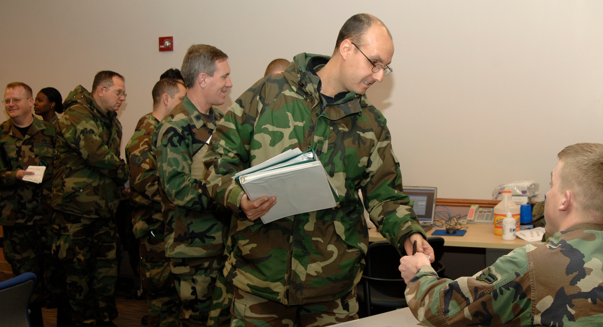 Team McConnell members line-up to process through a mock mobility deployment line Feb. 10, during an initial Response exercise. This exercise tested McConnell’s deployment readiness on a moments notice. (Photo by Airman 1st Class Laura Suttles) 
